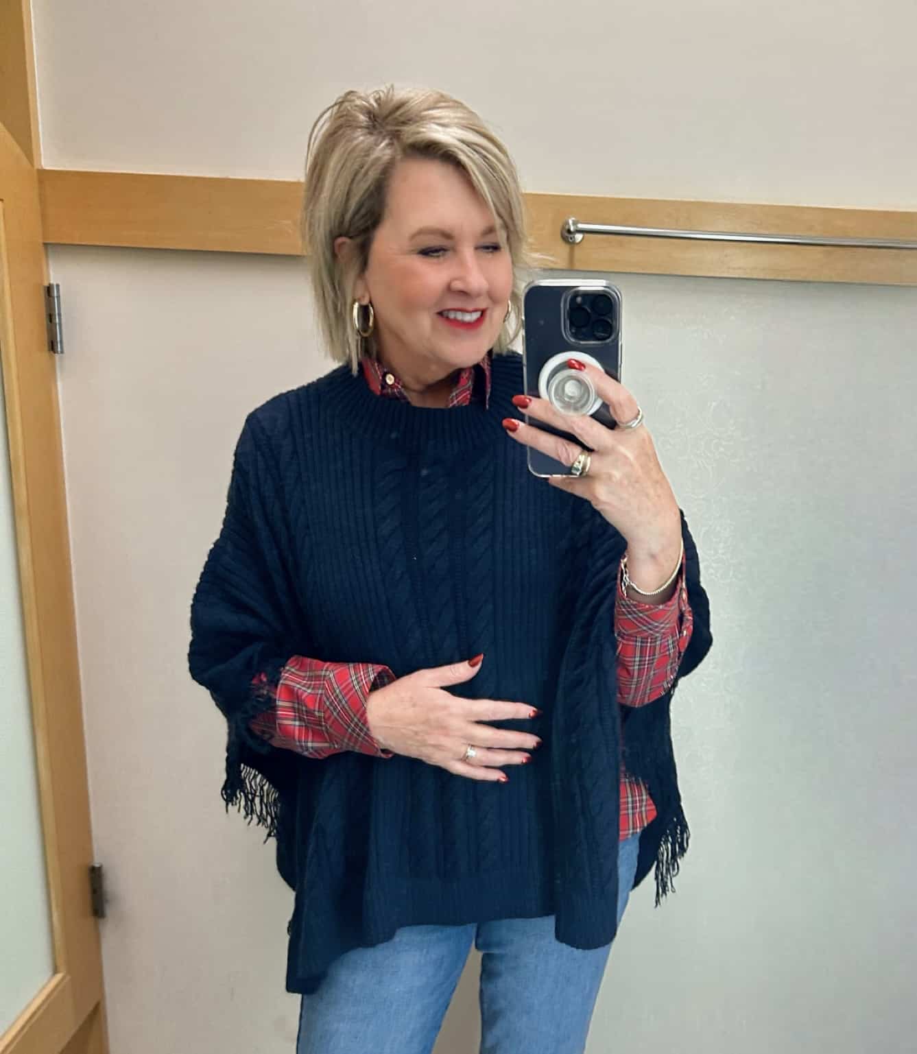 Tania Stephens wearing a navy cable knit poncho from Talbots