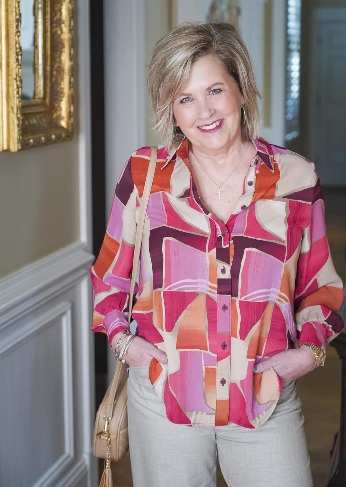 Tania Stephens is wearing a colorful faux silk collared shirt 