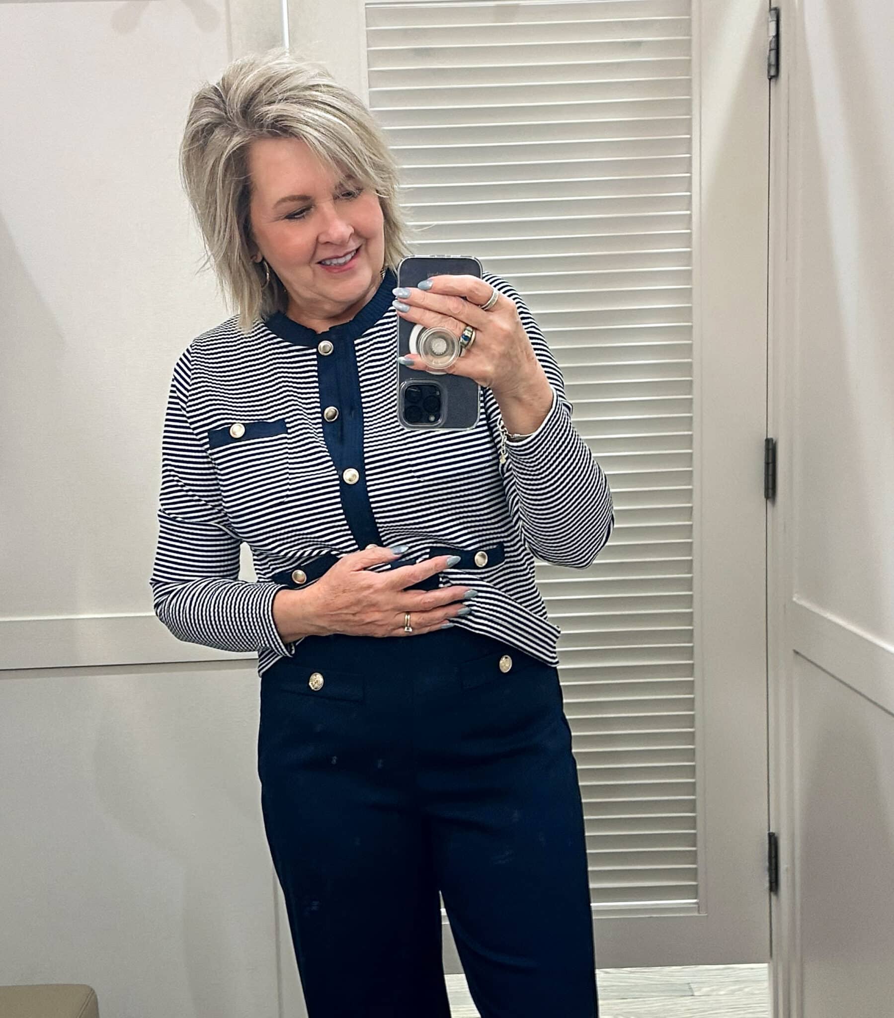 Tania Stephens is wearing a navy & white top and navy pants from Loft