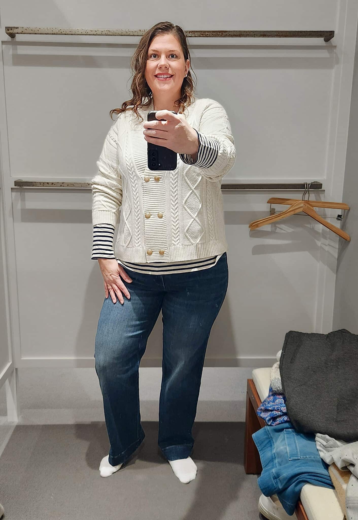 Megan is wearing a striped shirt, a double breasted cardigan, and trouser jeans from J.Jill