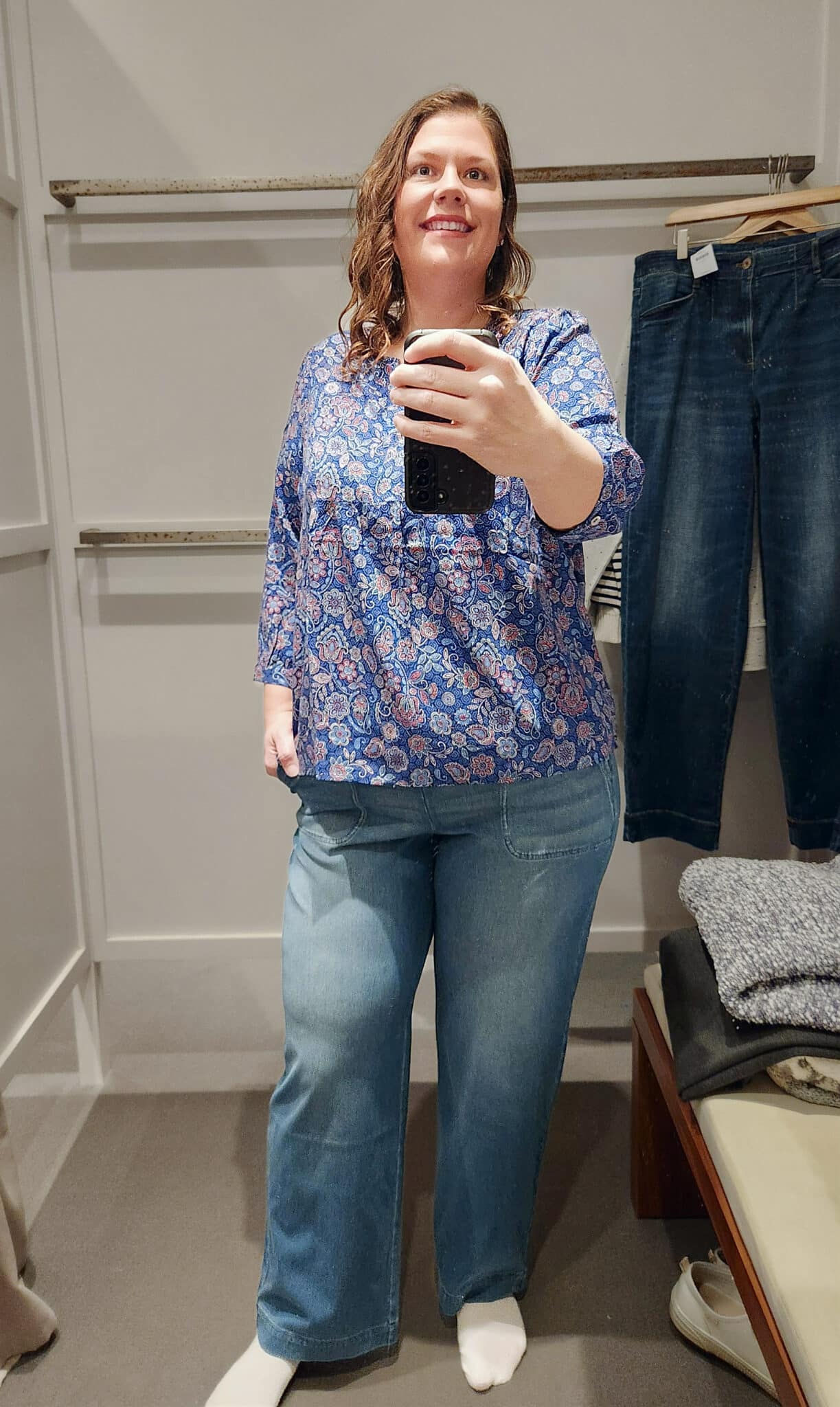Megan is wearing a blue top and trouser jeans from J.Jill
