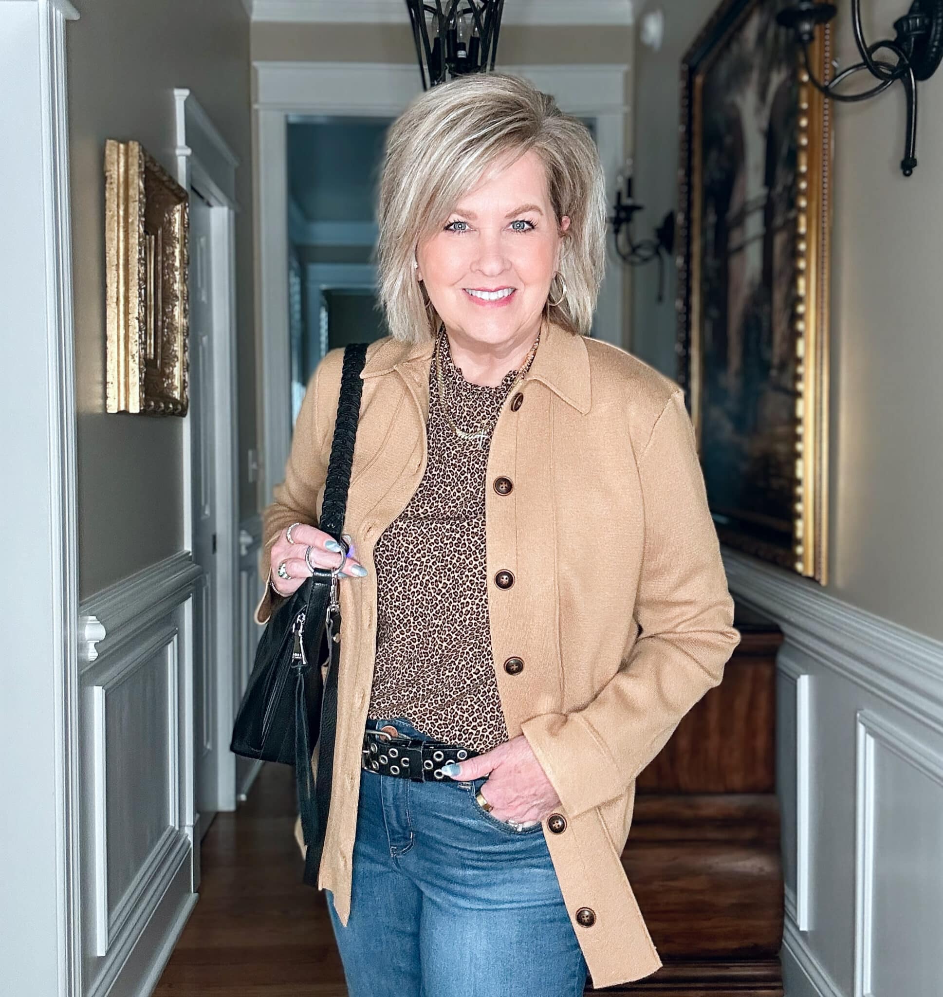 Tania Stephens is wearing a leopard print top, a camel knit blazer and jeans