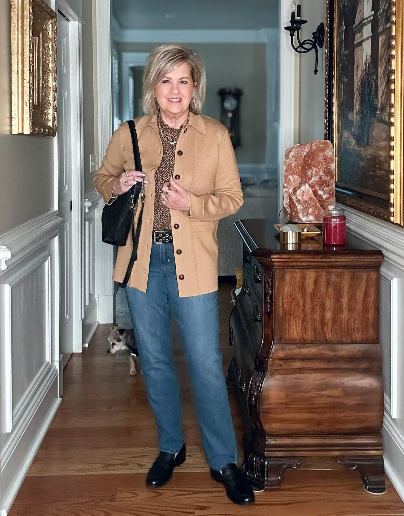 Tania Stephens is wearing a leopard print top, a camel blazer and jeans
