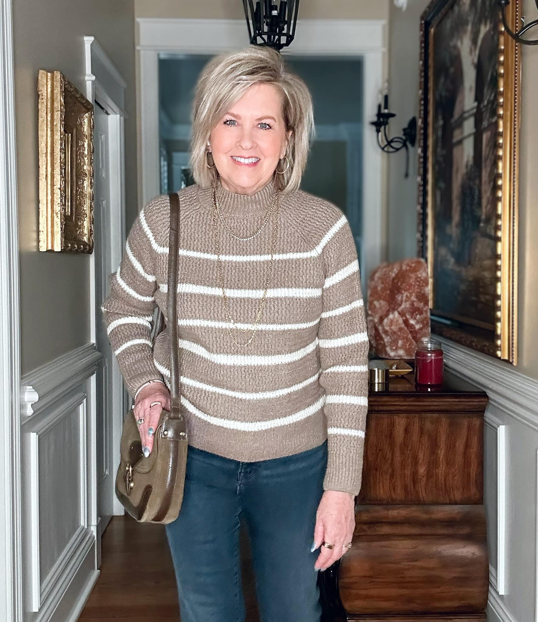 Tania Stephens is wearing a striped mocha colored sweater and jeans