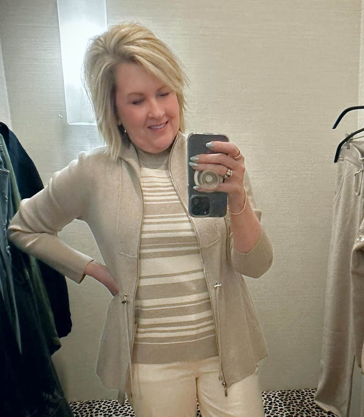 Tania Stephens from 50 Is Not Old is wearing a taupe jacket and an ivory striped tank