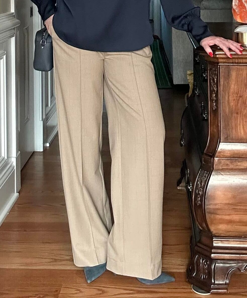 Over 50 fashion blogger, Tania Stephens is wearing  checked tan pants