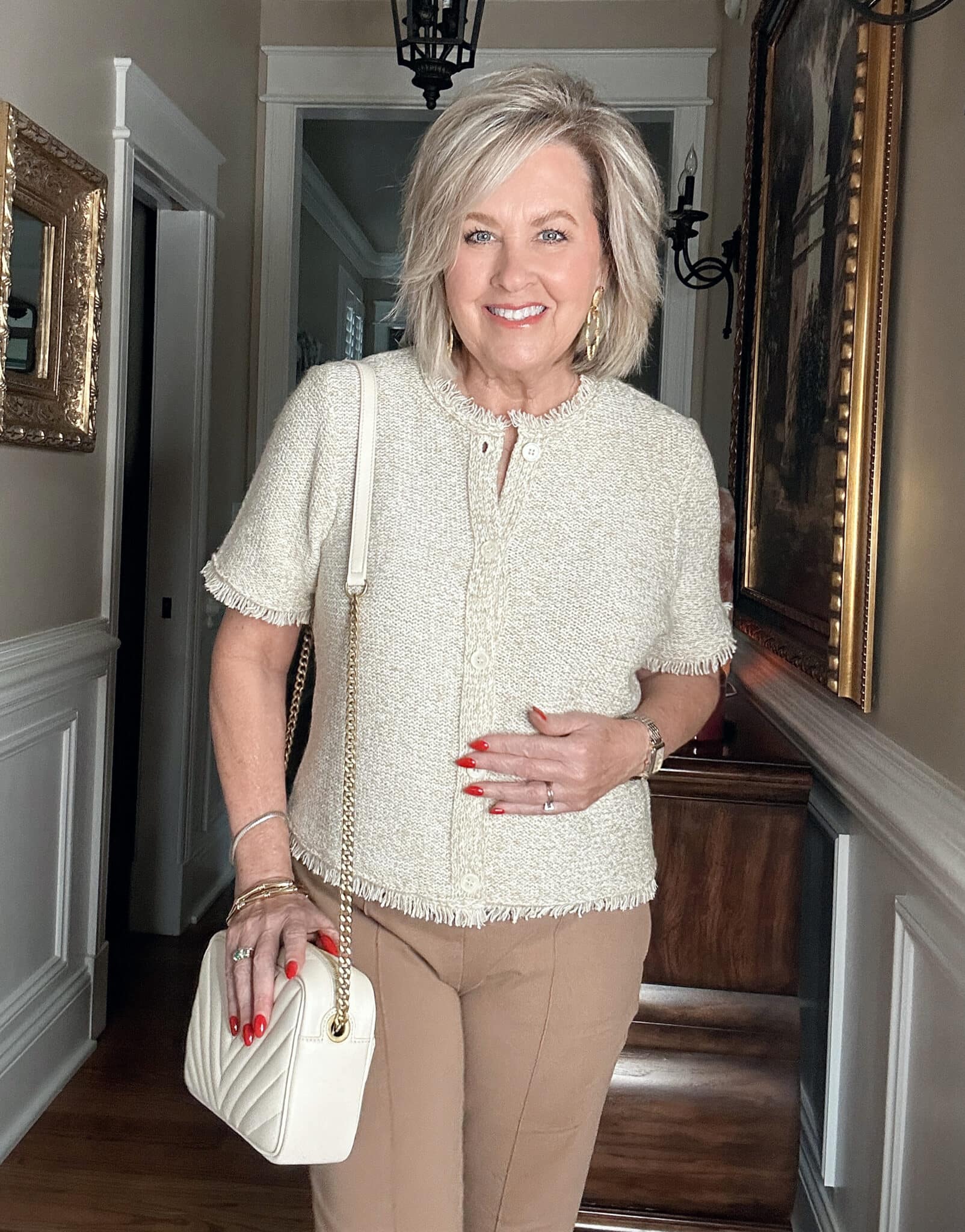 Over 50 Fashion Blogger, Tania Stephens is wearing a neutral outfit consisting of a beige fringed top 