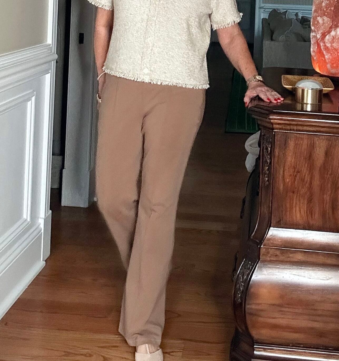 Over 50 Fashion Blogger, Tania Stephens is wearing a neutral outfit consisting of a pair of tan pants