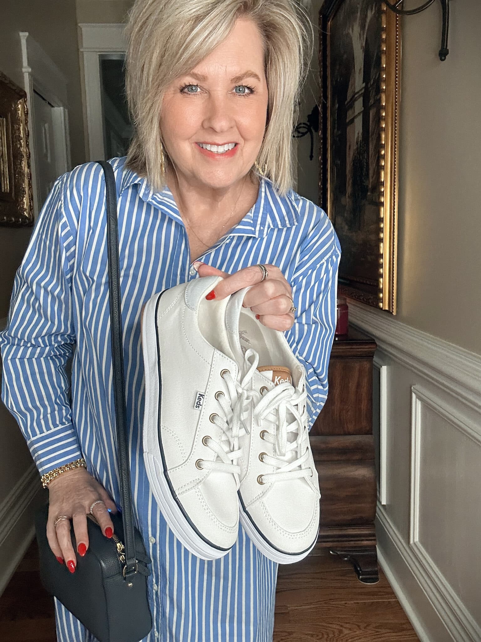 Over 50 Fashion Blogger, Tania Stephens is wearing a a striped dress with Keds sneakers