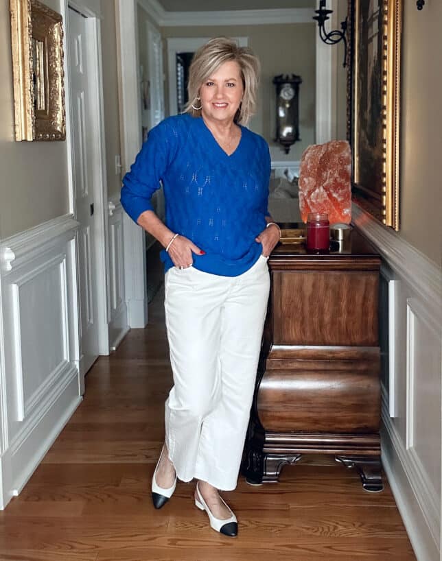 Tania Stephens is wearing a a cobalt blue sweater and wide leg white pants for a What I Wore series