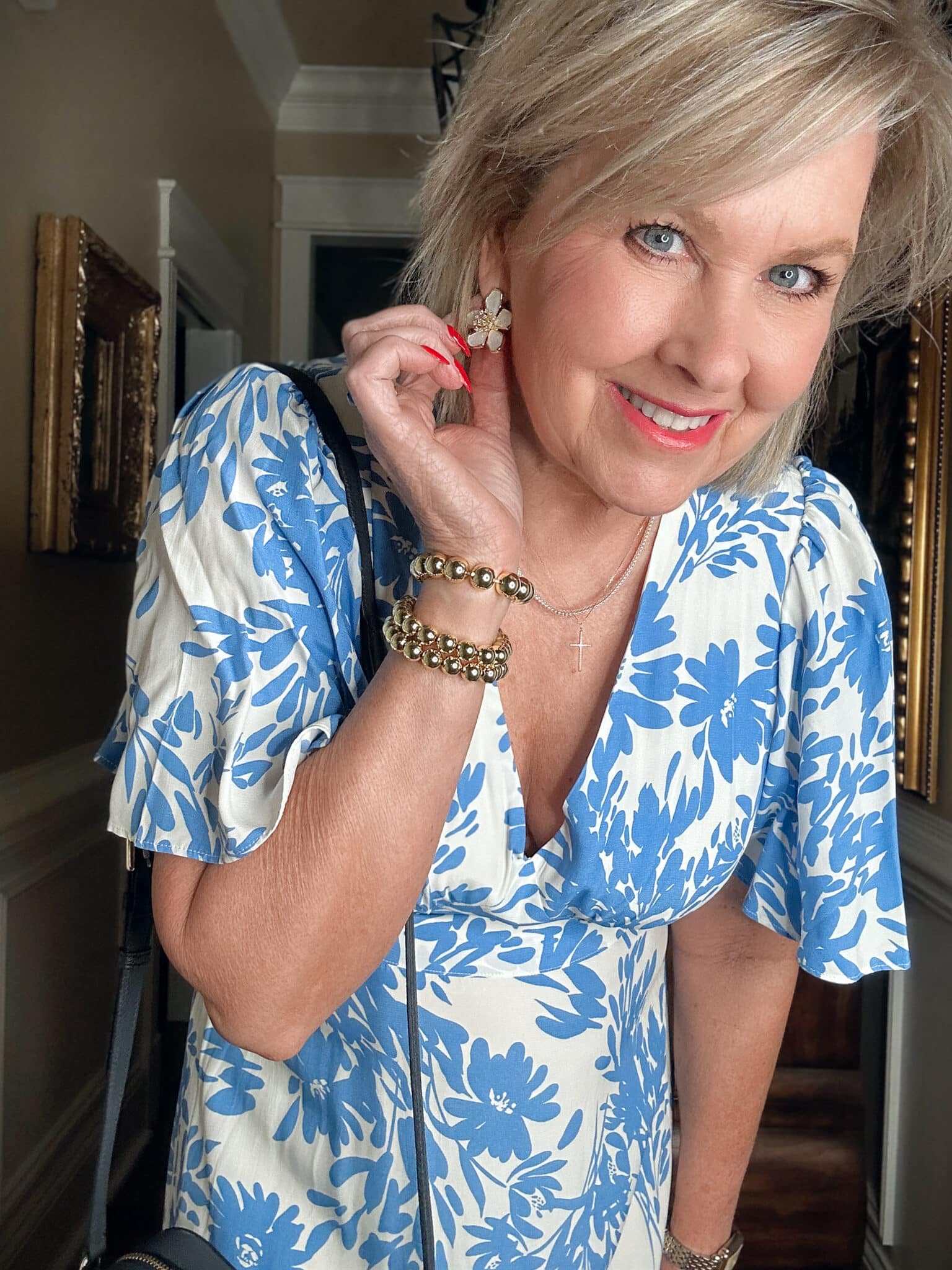 Tania Stephens wearing affordable and budget friendly clothing - a blue and white floral dress with flower earrings