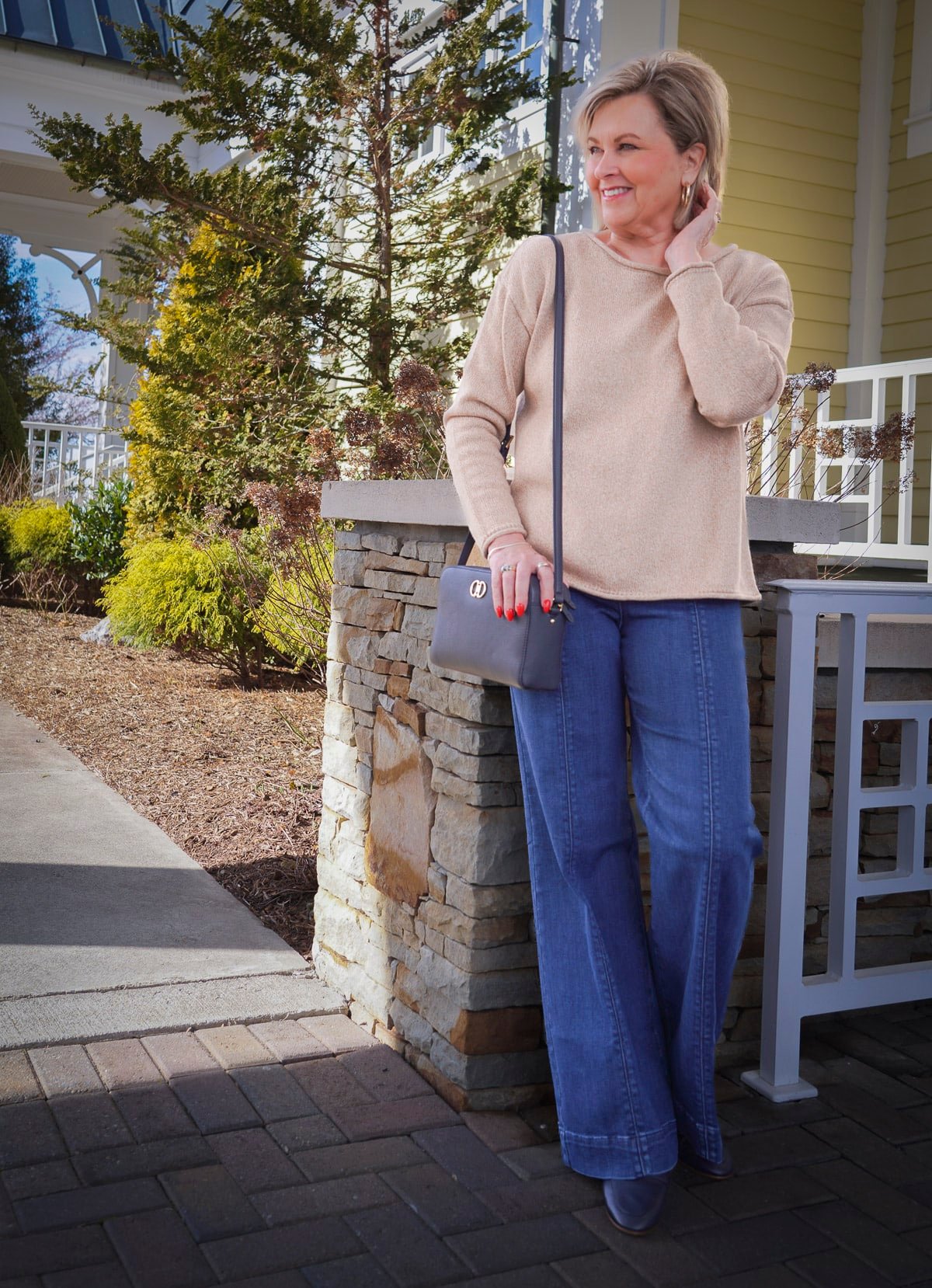 Tania Stephens, over 50 fashion blogger, wearing a rollneck sweater and wide leg jeans from Talbots