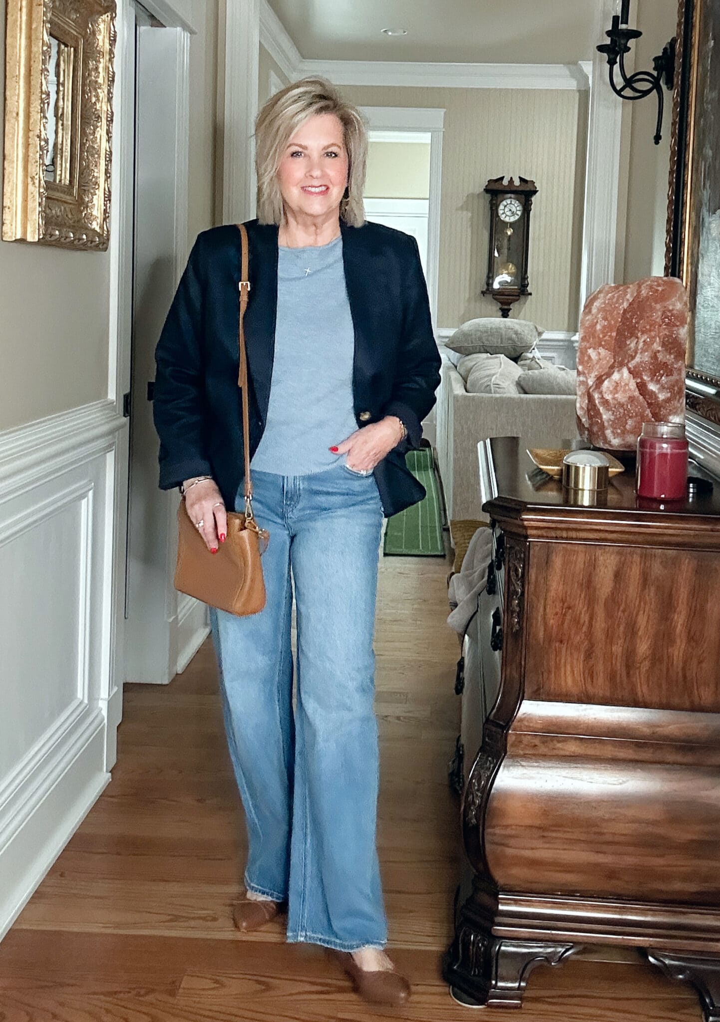 Tania Stephens, Over 50 Fashion Blogger, wearing a powder blue sweater, navy blazer, and wide leg jeans from Quince