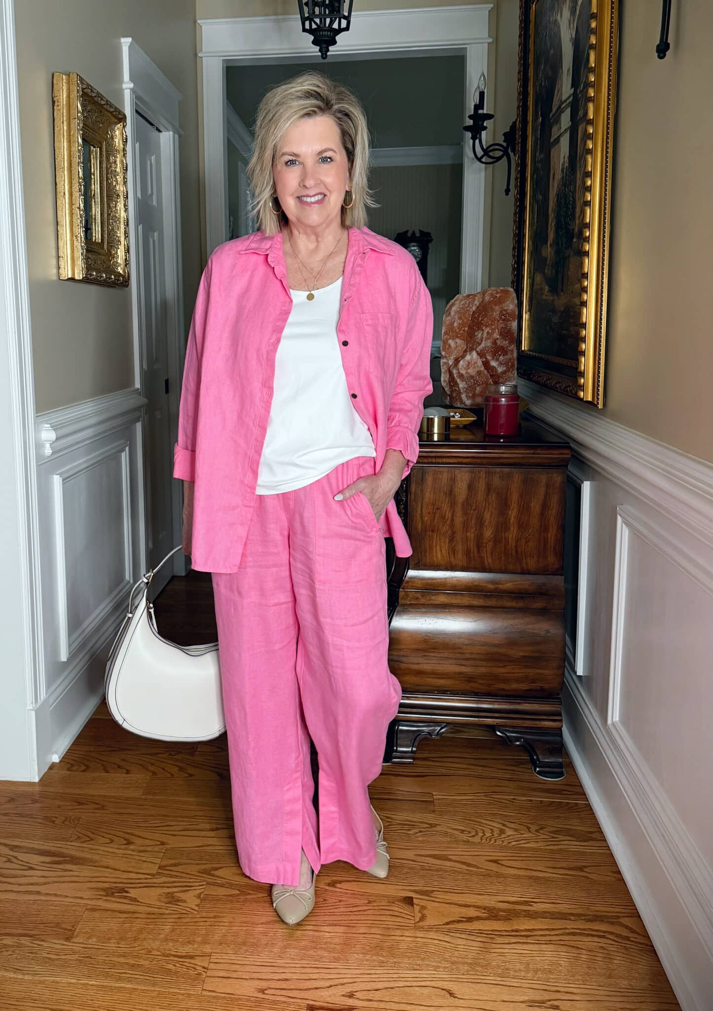 Tania Stephens is wearing a bright pink linen palazzo pants from Athleta