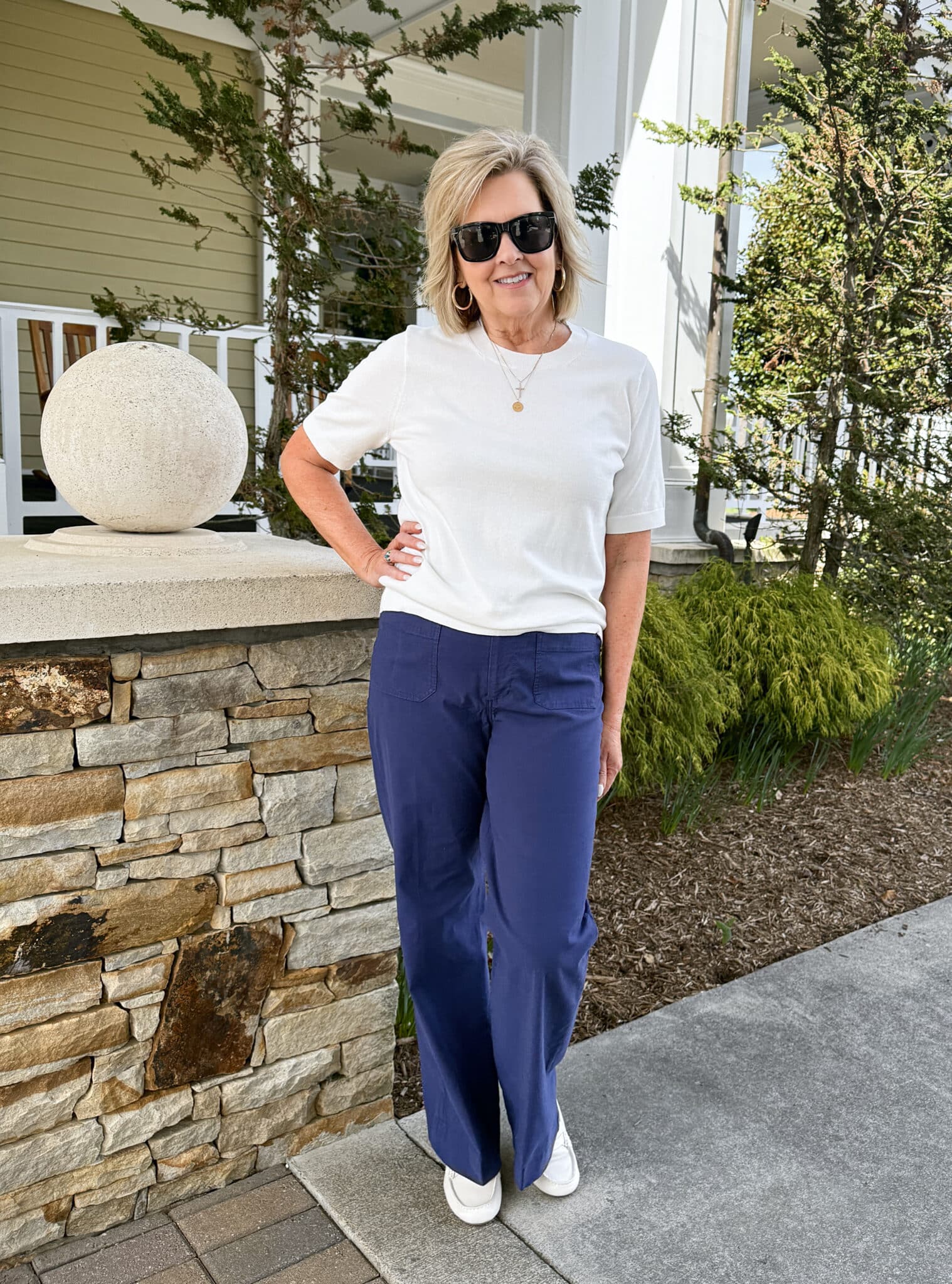 Tania Stephens wearing a white short sleeve sweater and navy patch pocket pants from J.Crew Factory