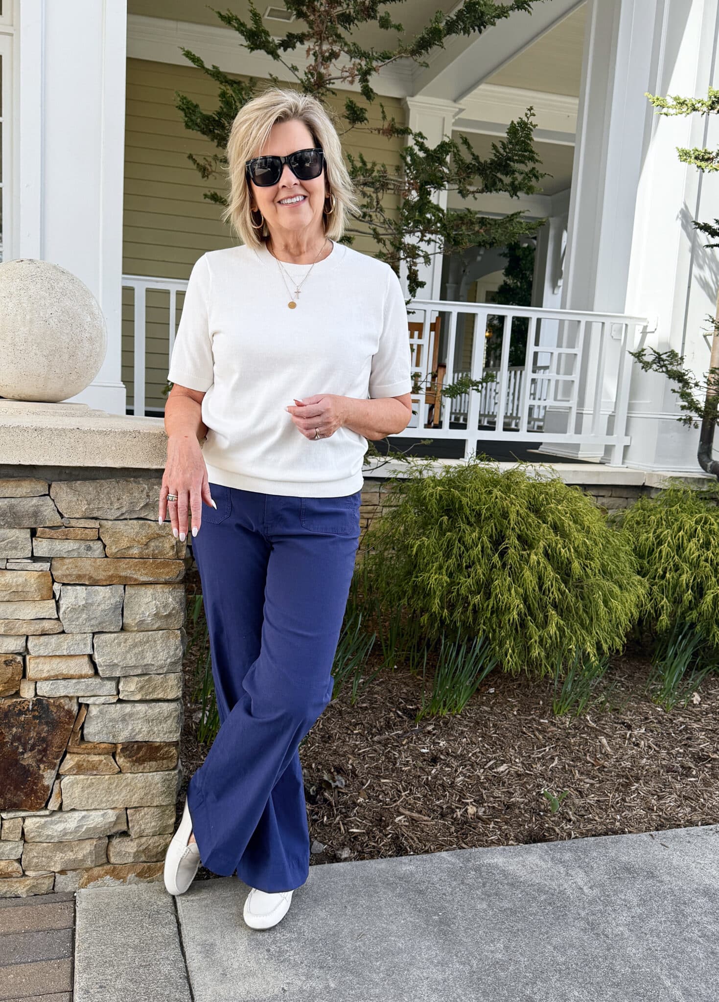 Tania Stephens wearing a white short sleeve sweater and navy patch pocket pants