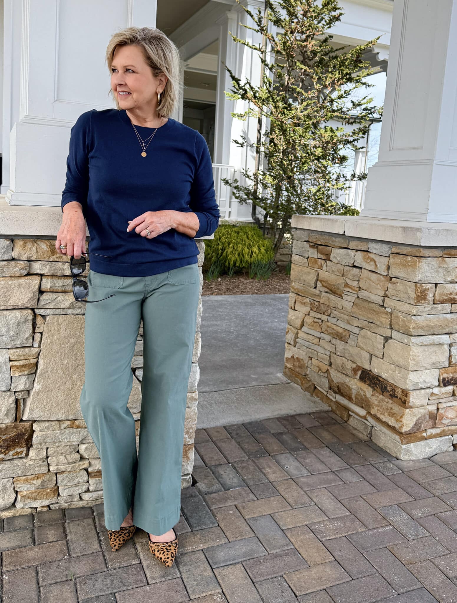 Tania Stephens wearing a navy long sleeve sweater and green patch pocket pants from J.Crew Factory