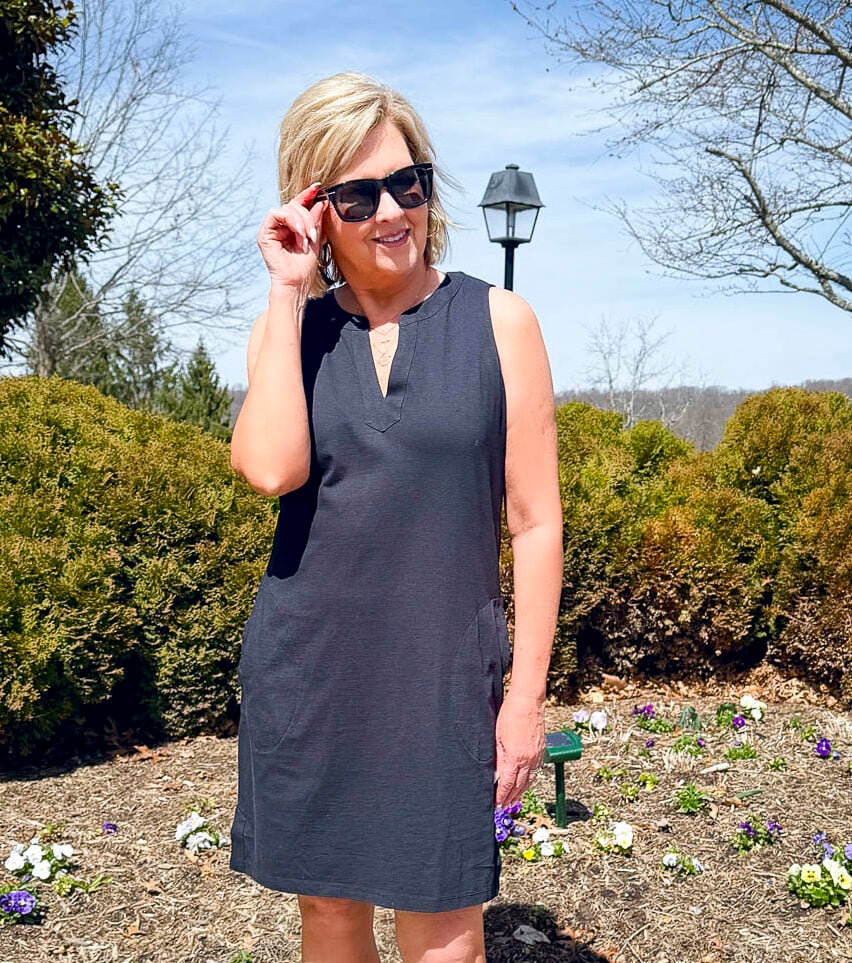 Tania Stephens is wearing a black dress with black sunglasses from Lands' End at Nordstrom