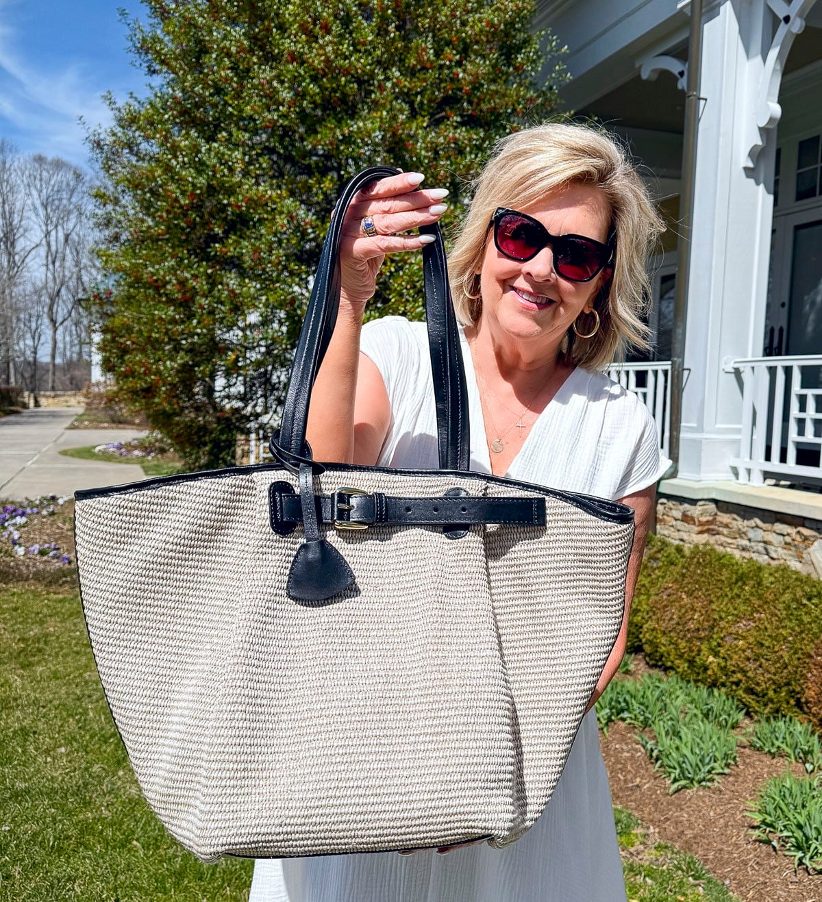 Tania Stephens wearing 2025 Spring styles of a white smocked waist with a straw tote bag from Nordstrom Rack
