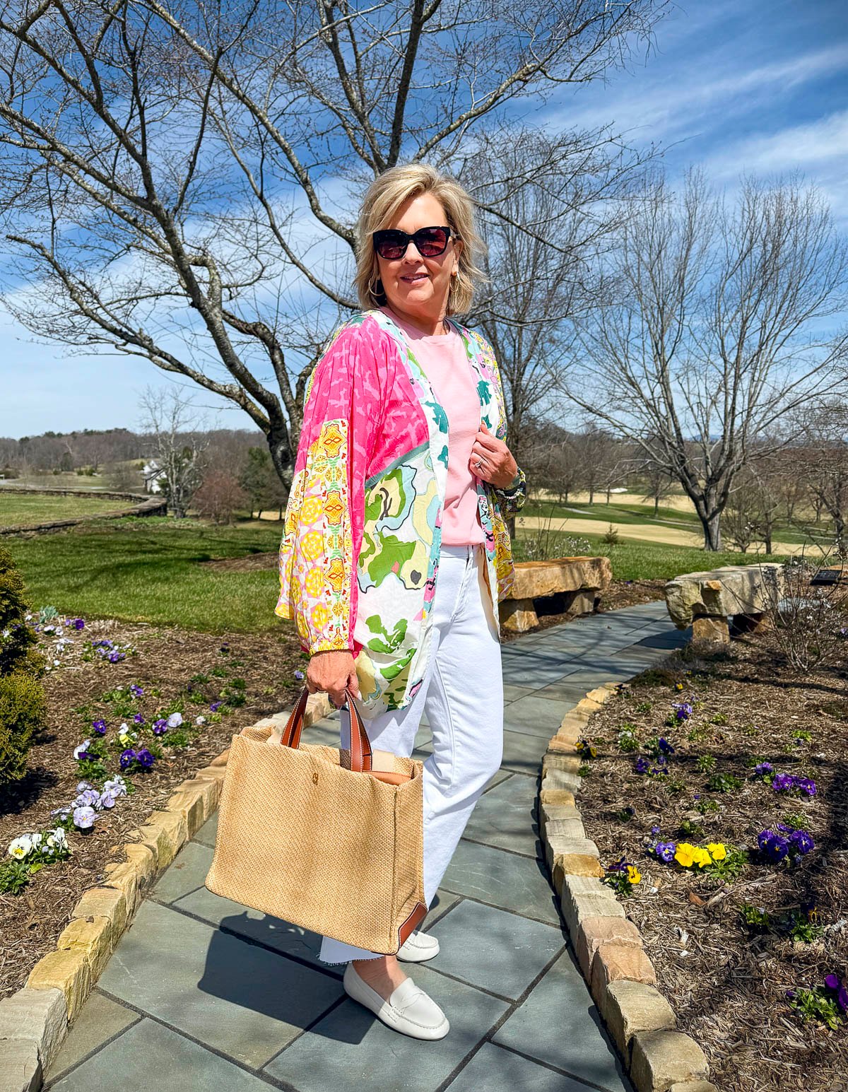 Tania Stephens wearing 2025 Spring styles of a colorful jacket, a pink tee, and white jeans from Nordstrom Rack