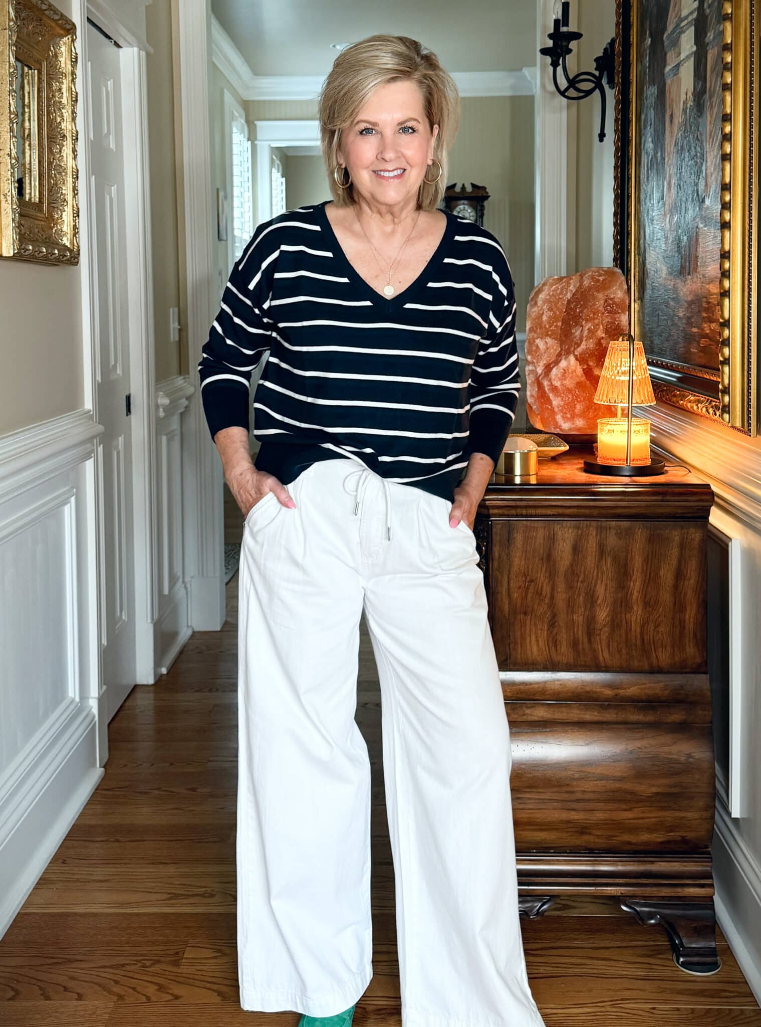 Tania Stephens is wearing a black & white sweater with wide leg jeans from Old Navy