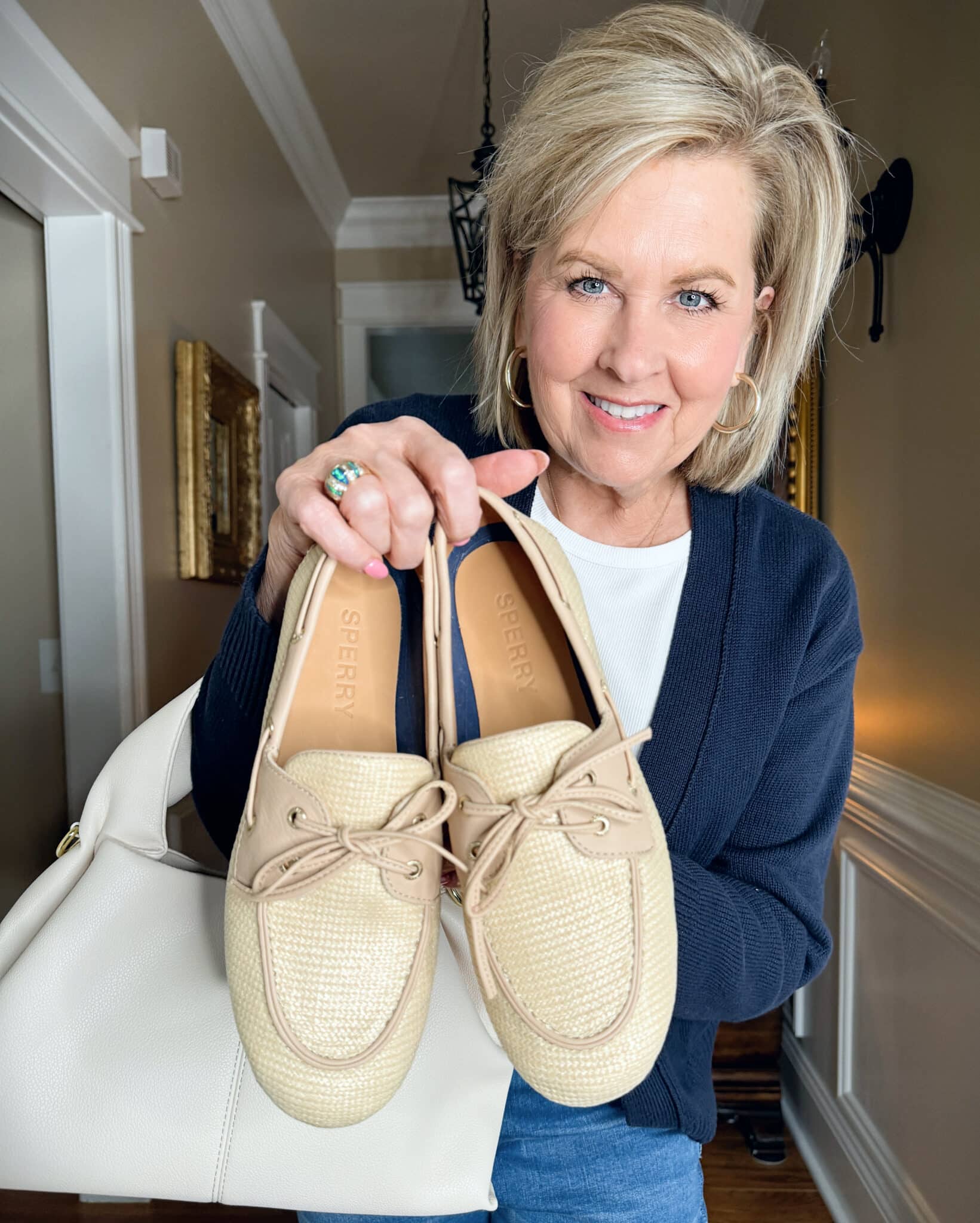 Tania Stephens is wearing a tee and holding Sperry boatshoes