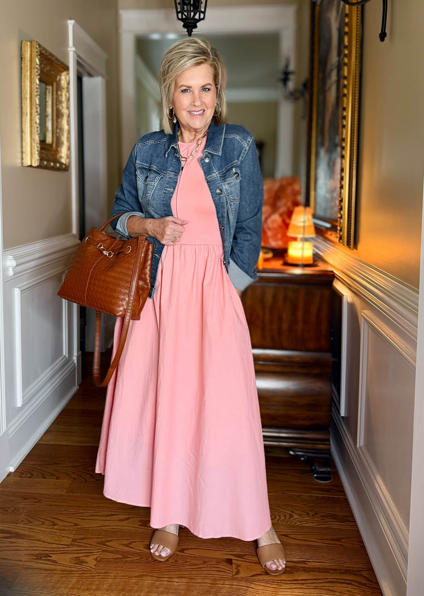 Casual pink maxi dress styled with denim jacket and brown crossbody