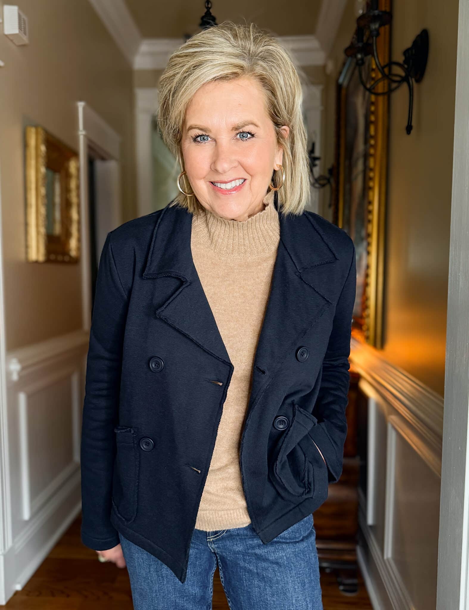 Tania Stephens wearing a cashmere turtleneck tee and a navy cropped blazer from Evereve