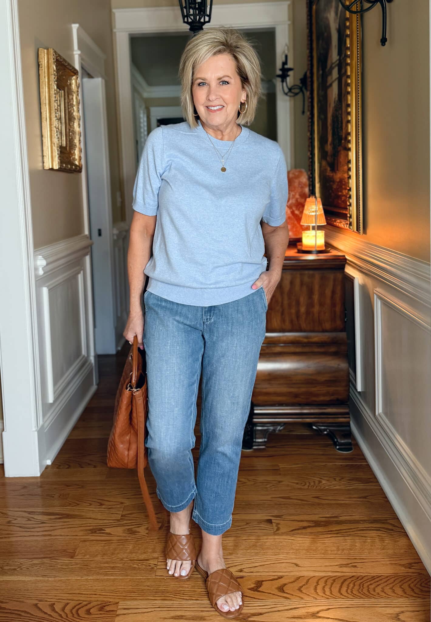 Tania Stephens is wearing a light blue sweater with jeans from J.Crew Factory