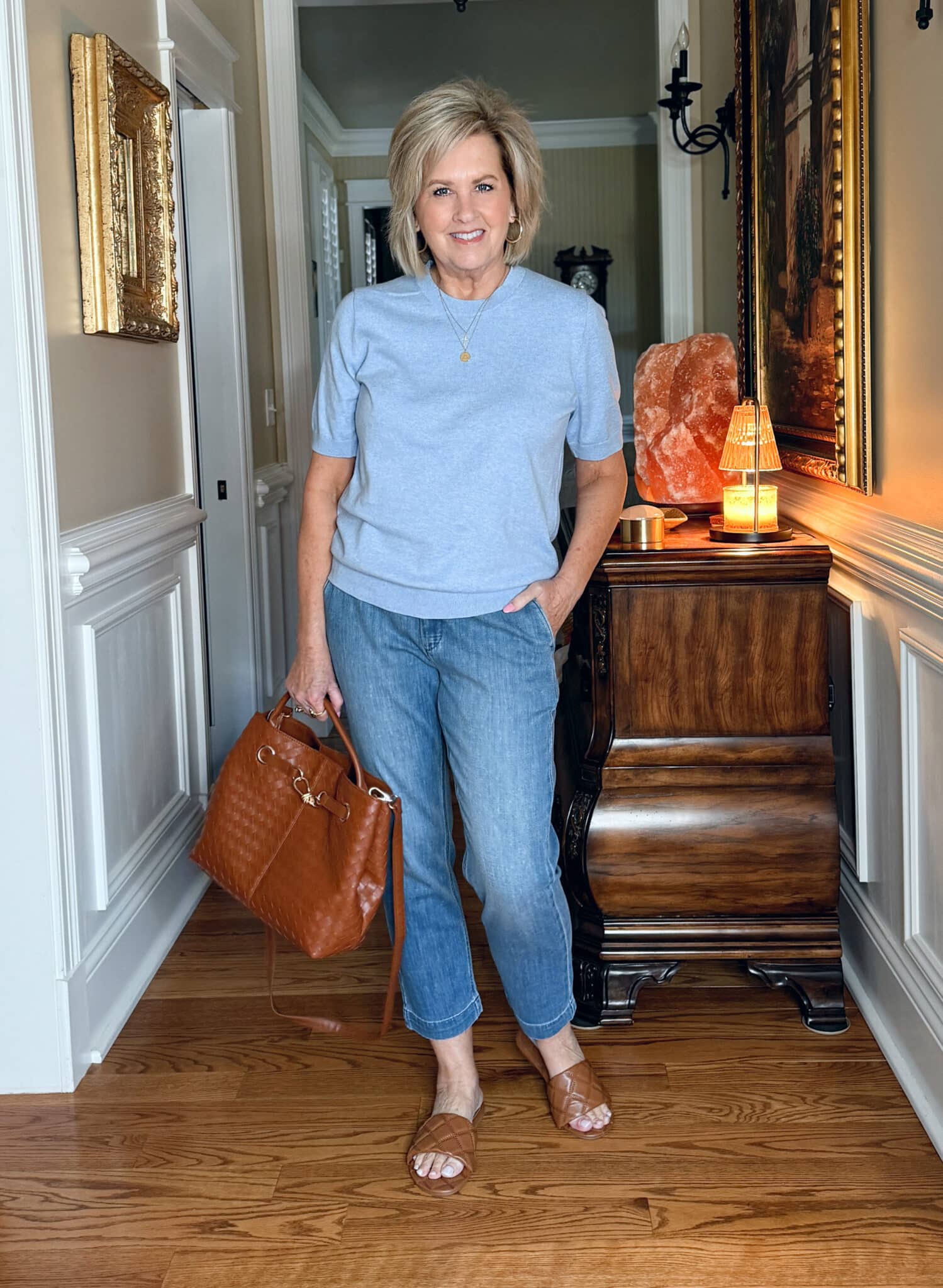 Tania Stephens is wearing a blue sweater with jeans from J.Crew Factory