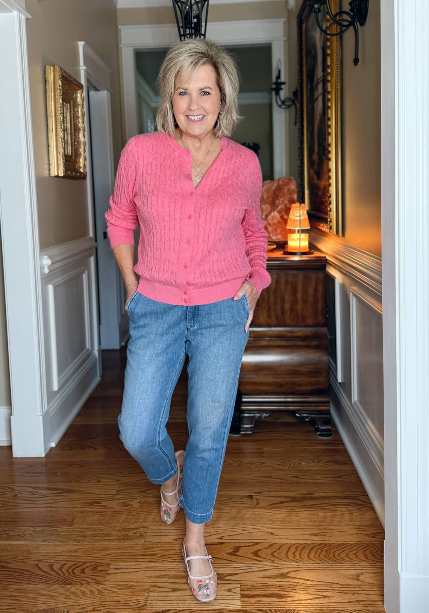 Tania Stephens is wearing a medium pink sweater cardigan with jeans from J.Crew Factory