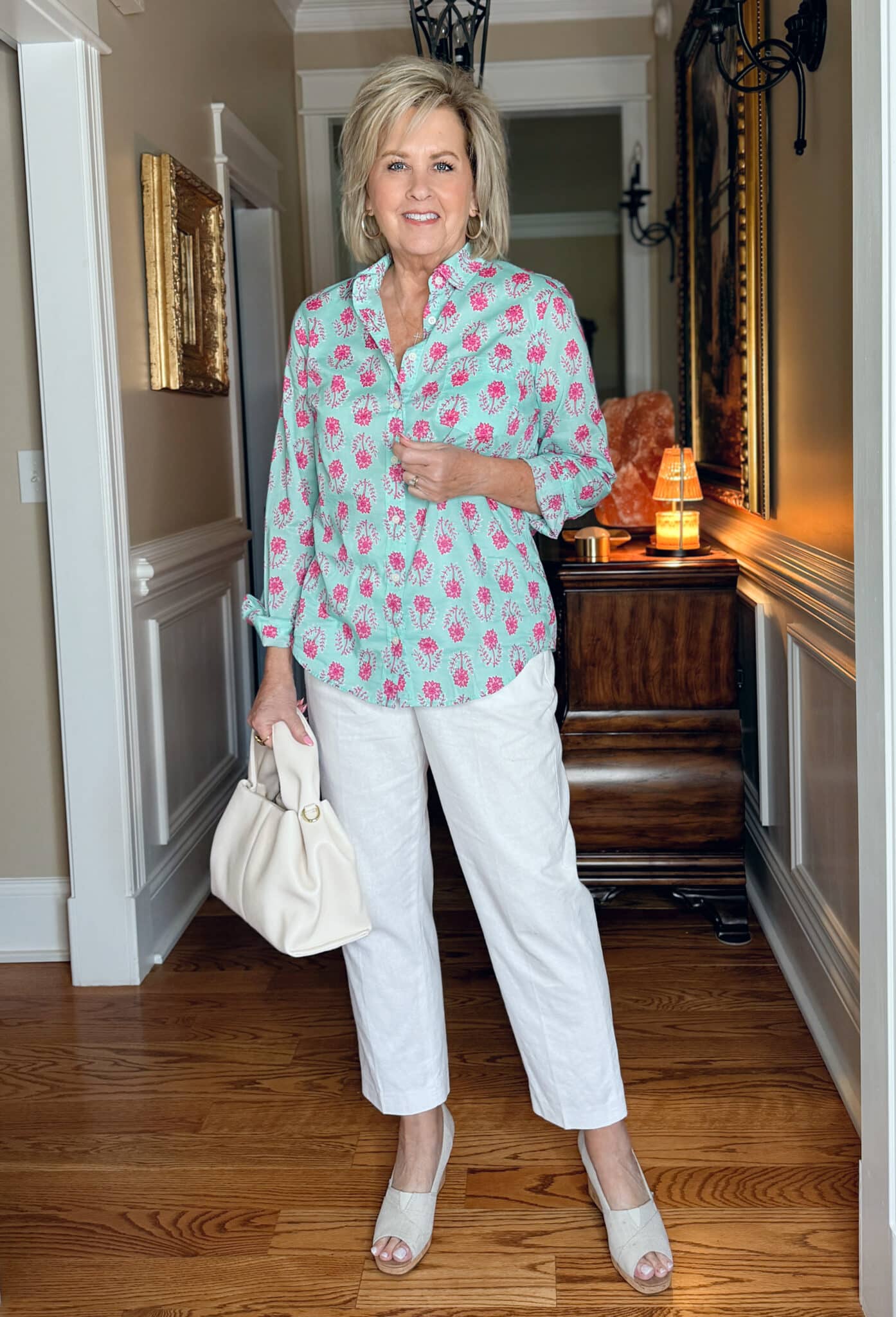Tania Stephens wearing a printed button shirt with white pants for spring and summer