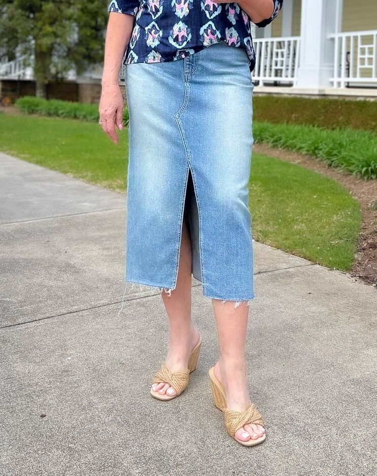 a woman wearing a skirt and sandals