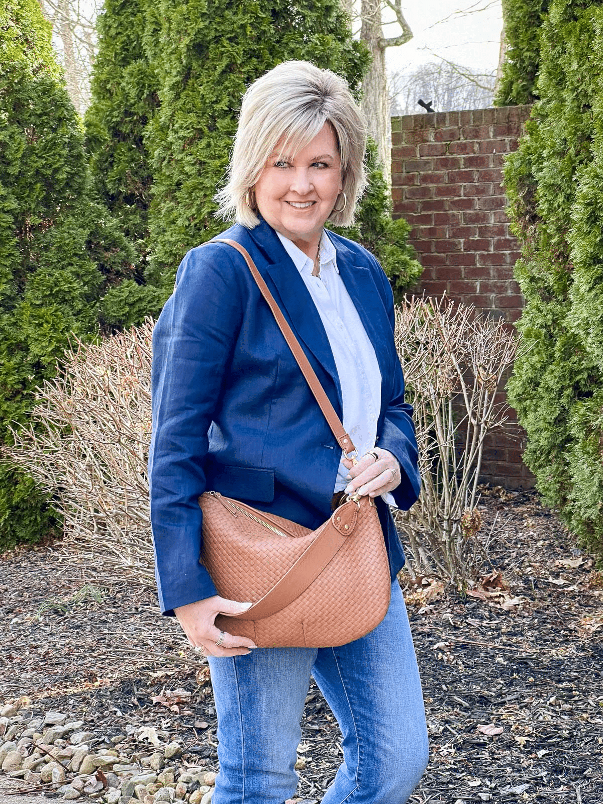 Close up of Convertible Crescent Handwoven Shoulder Bag from Quince shown worn over the shoulder