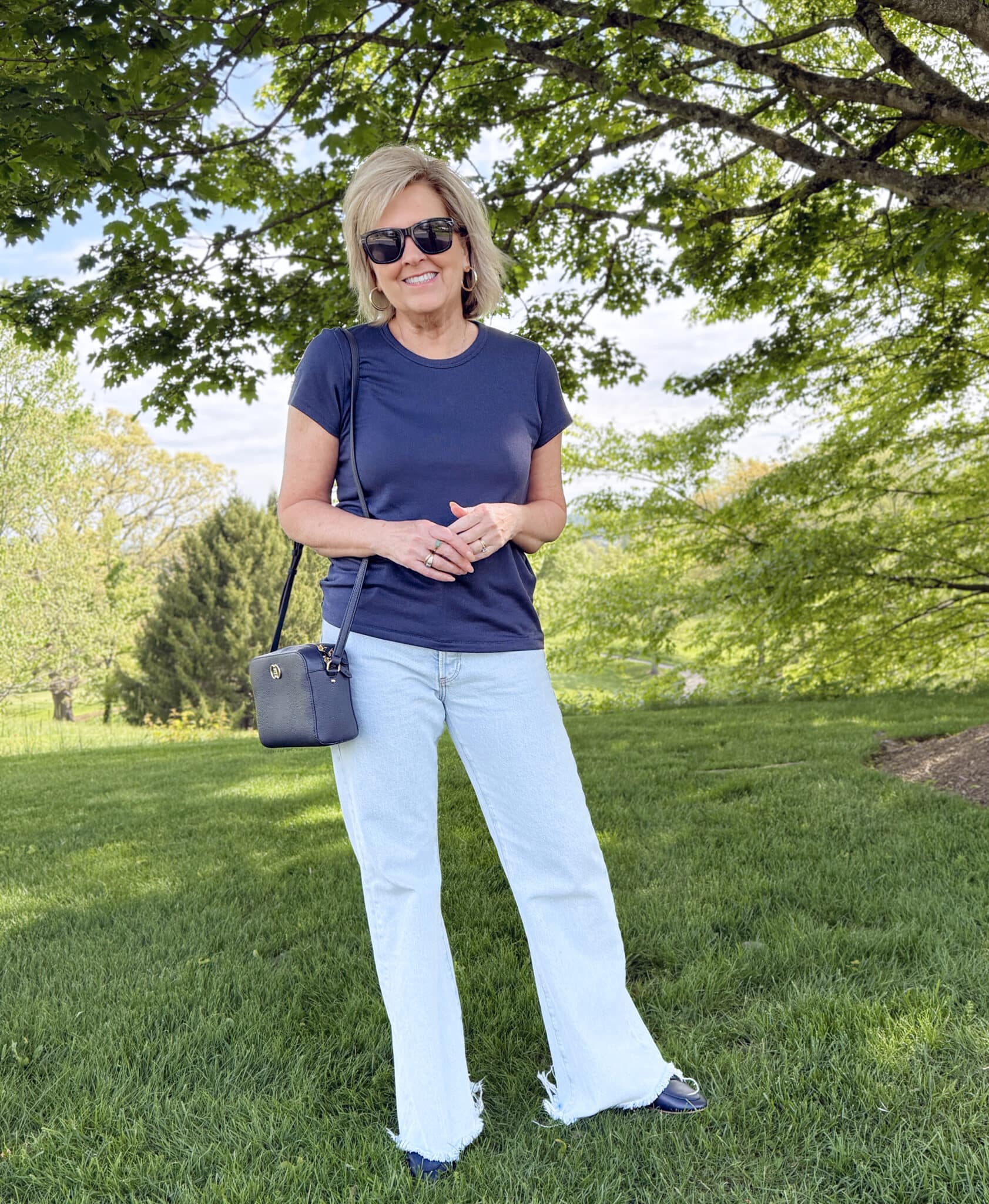 Summer outfit with light wash flare jeans and navy tee