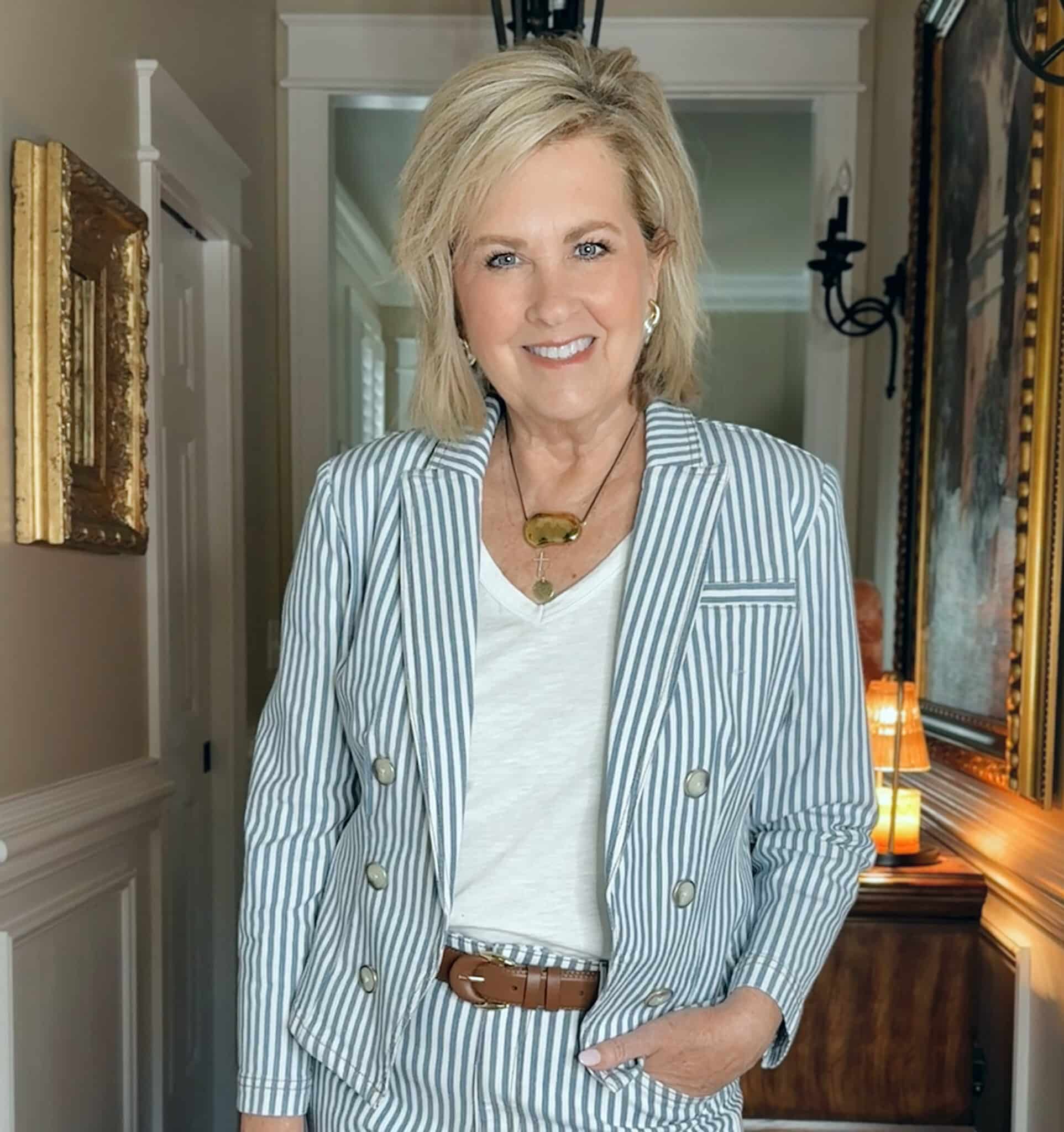 Woman over 50 wearing a striped blazer with a white tee