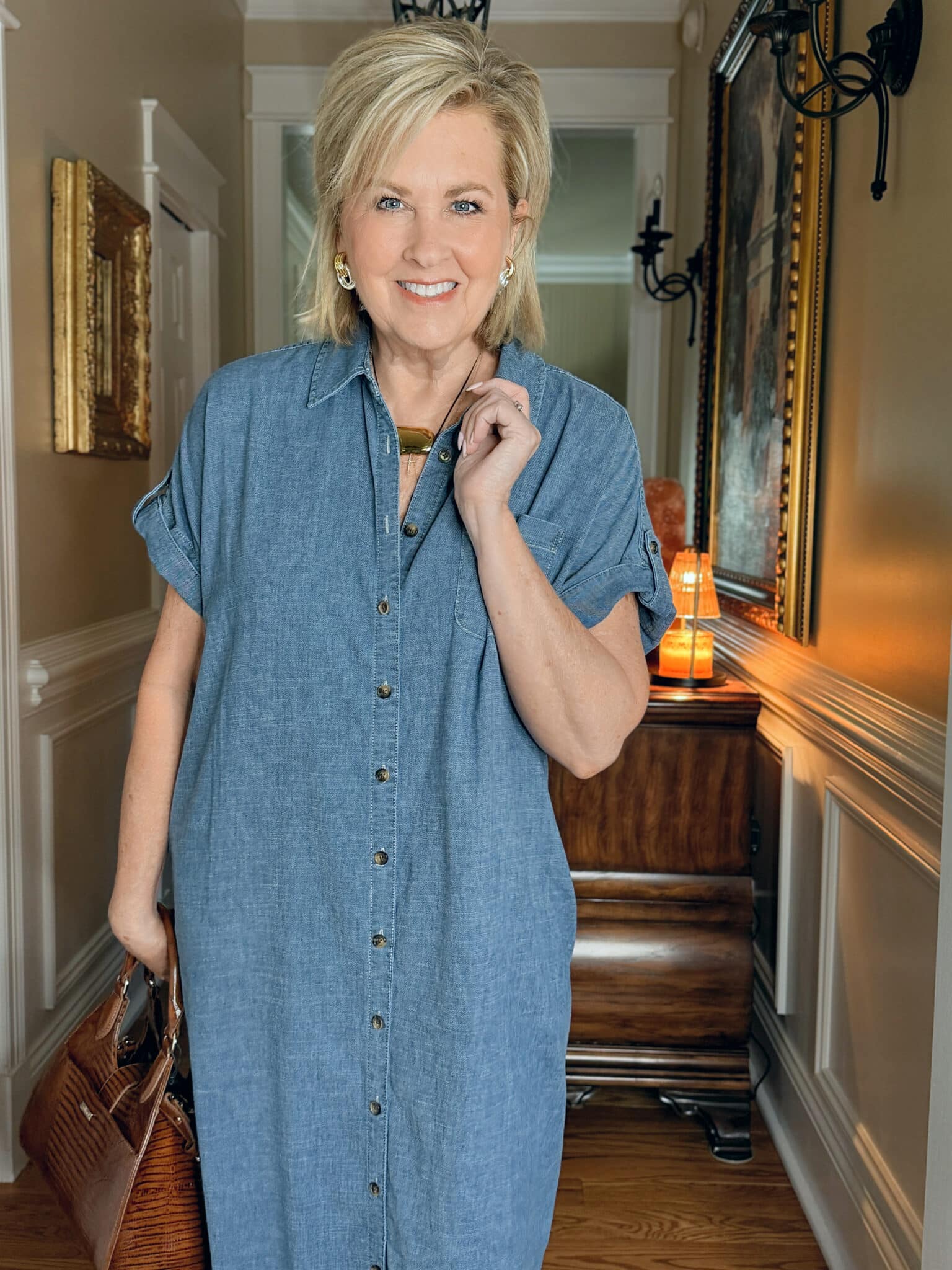 Woman over 50 in a chambray shirt dress