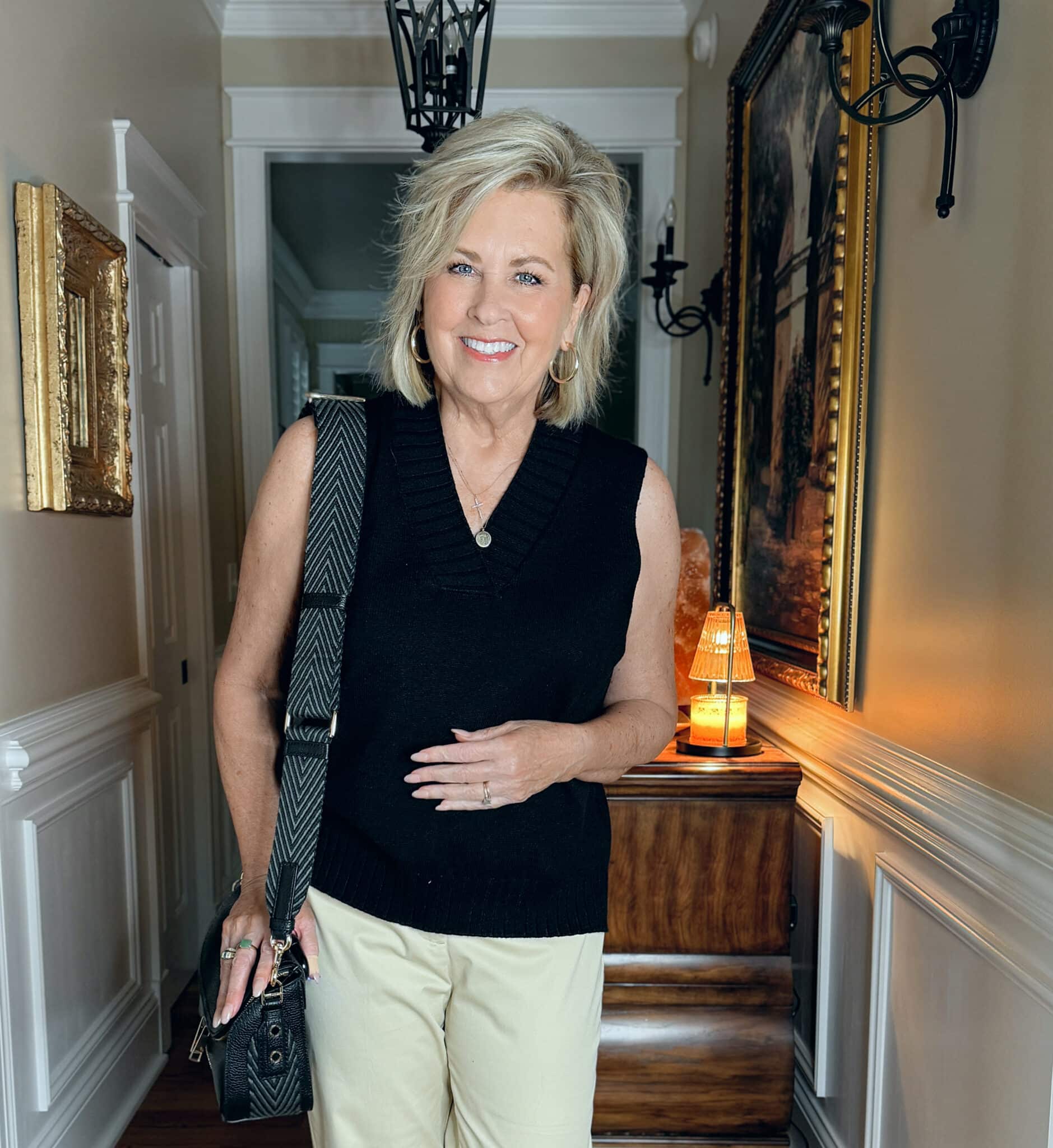 Woman wearing a long black sweater vest for spring