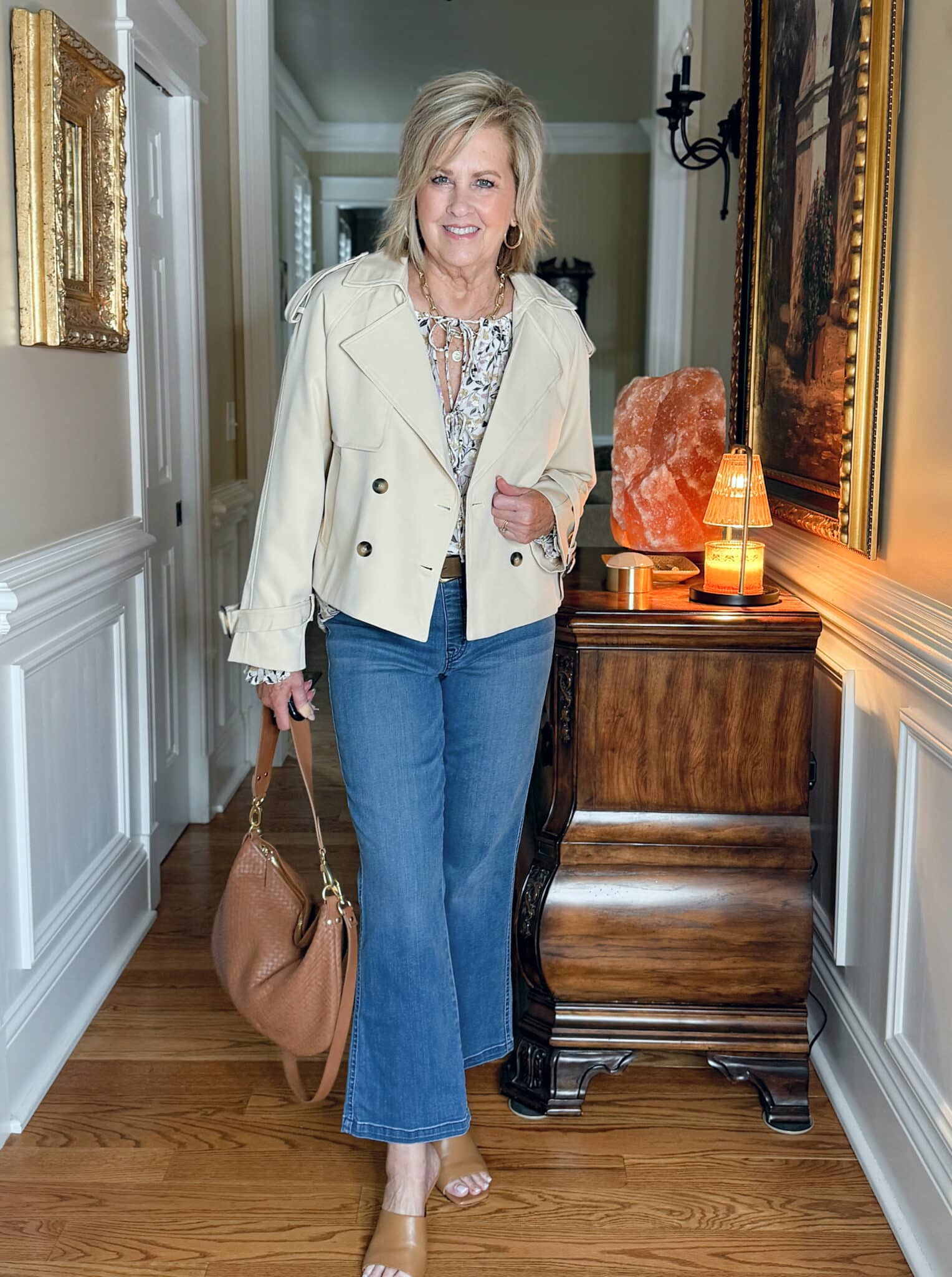 woman wearing an Ann Taylor tie top, cropped jeans, and a cropped trench for spring