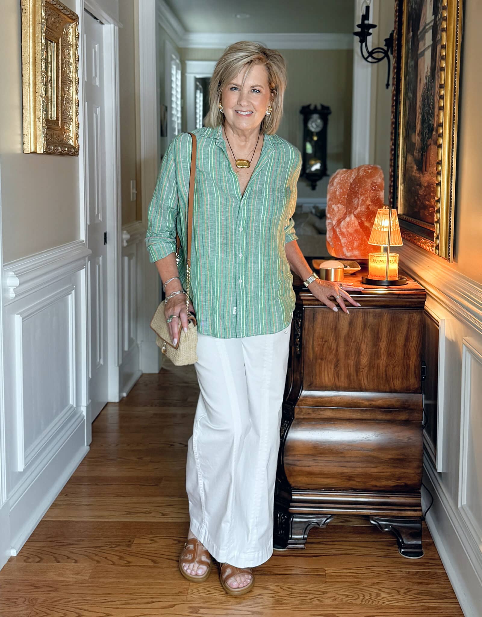 Tania Stephens wearing a pistachio green button-up with wide-leg pants, perfect for a relaxed summer look.