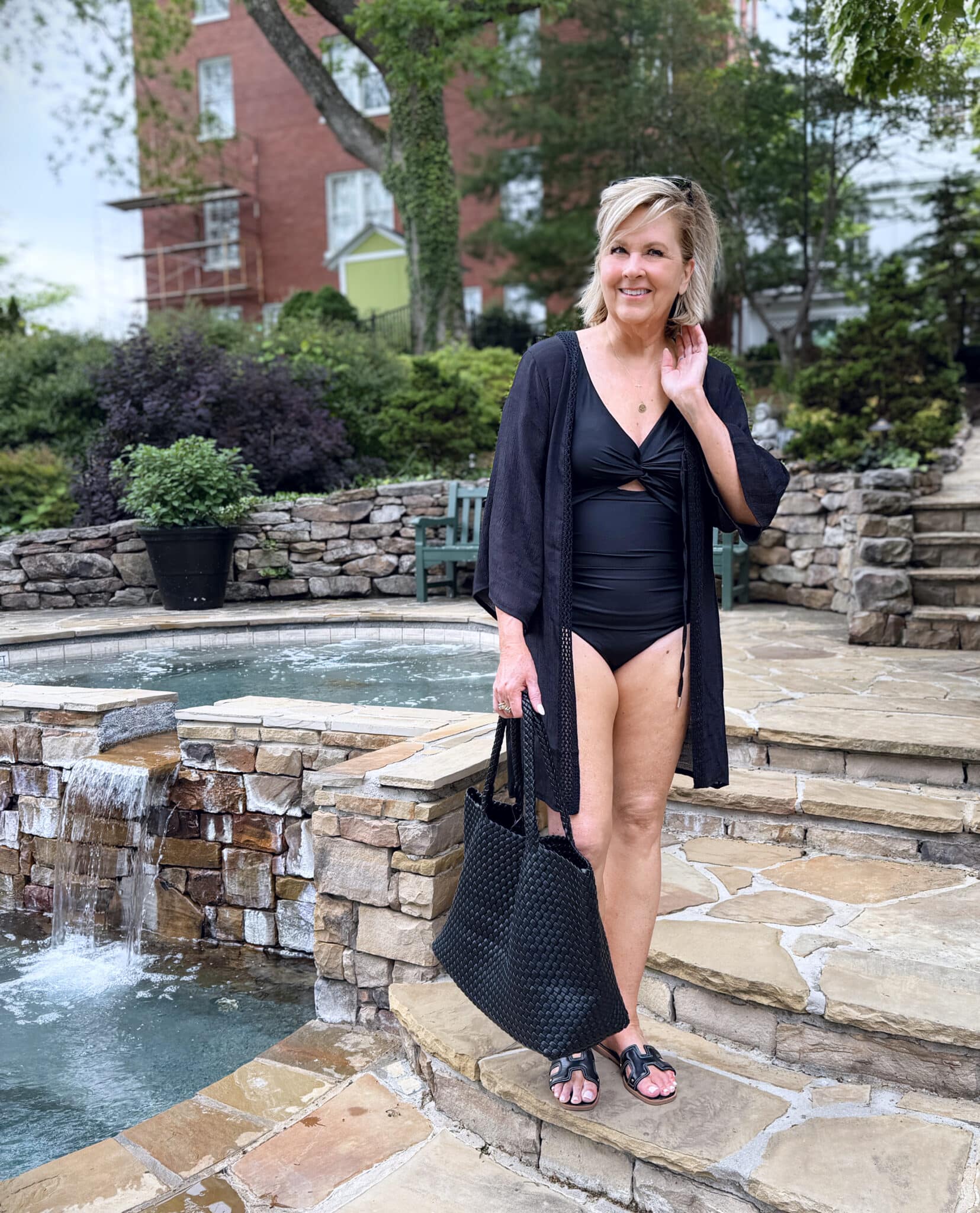 woman wearing a black one piece with a black cover up for summer from Nordstrom Rack