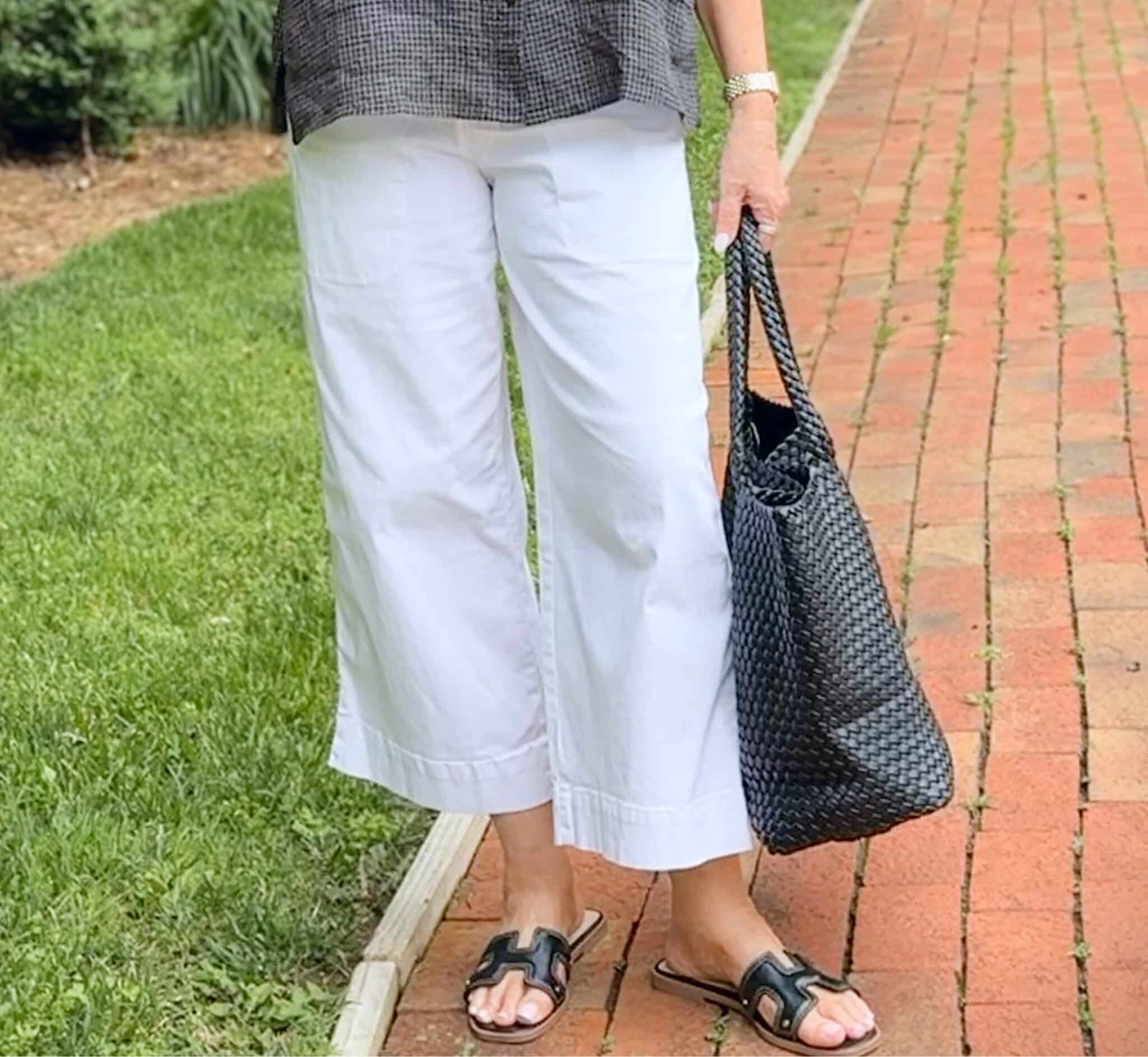 woman wearing white wide leg pants