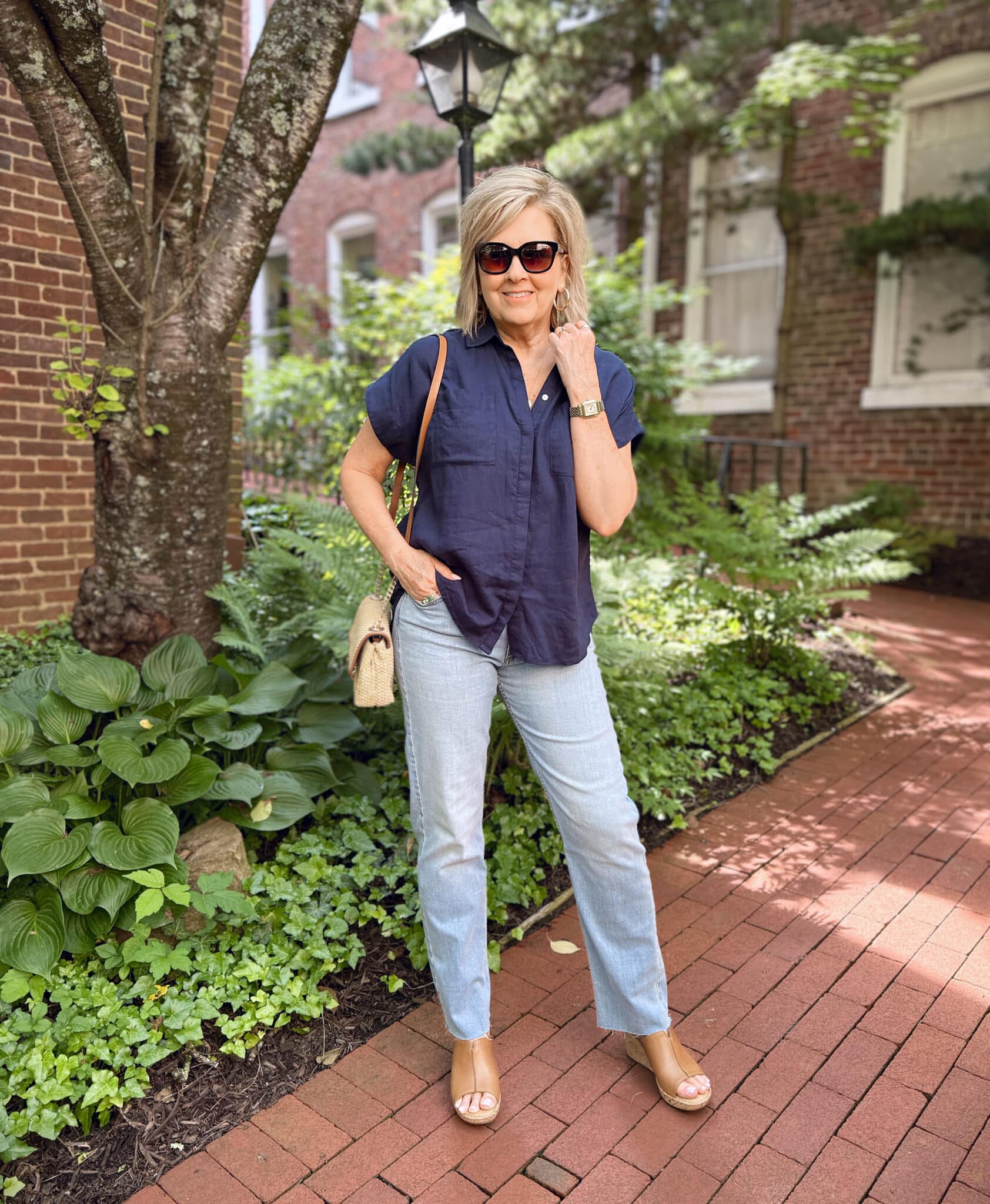 woman wearing navy short sleeve top and light wash jeans with wedge shoes for summer from Nordstrom Rack
