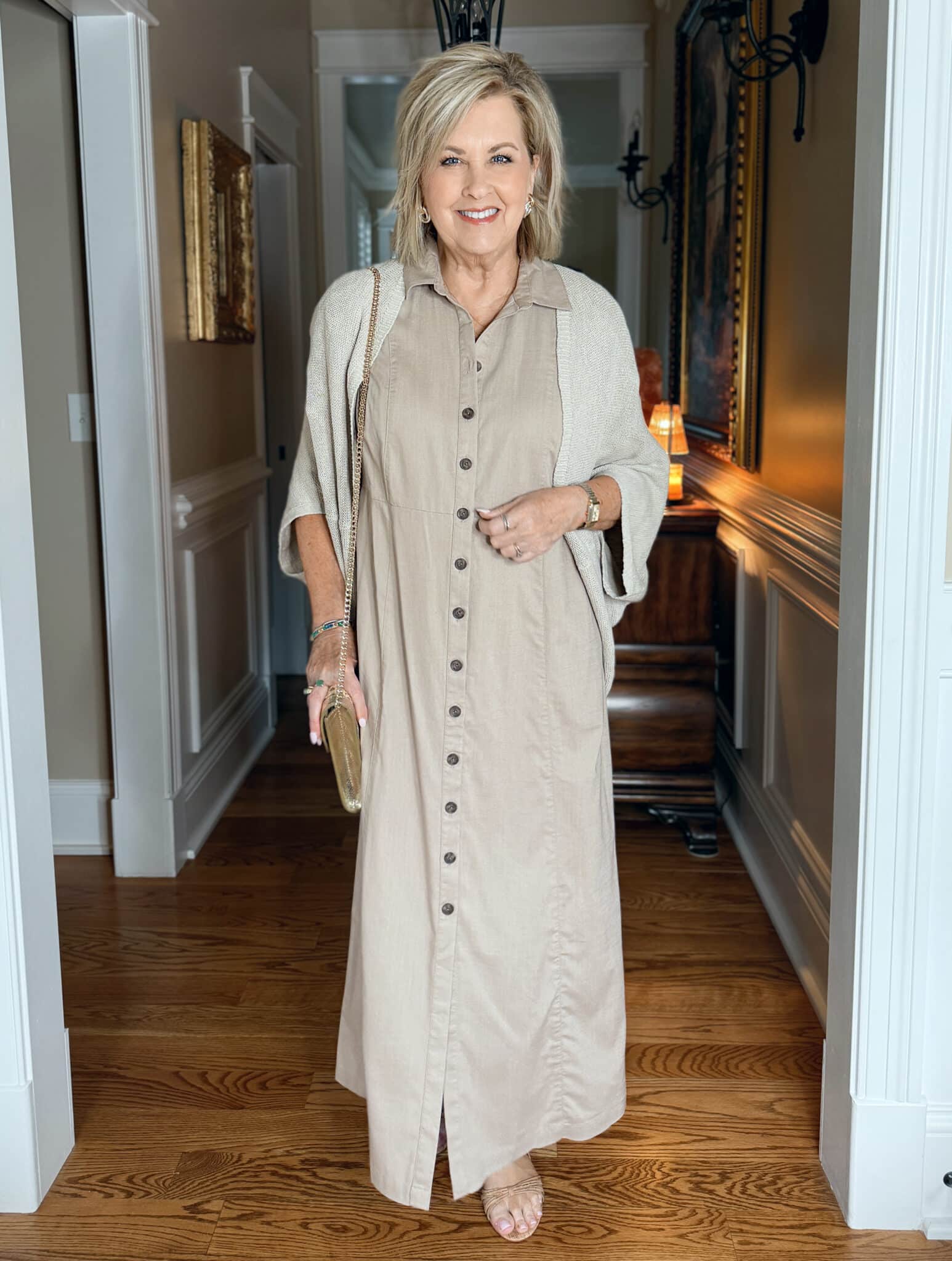 woman wearing long beige shirtdress and a shrug