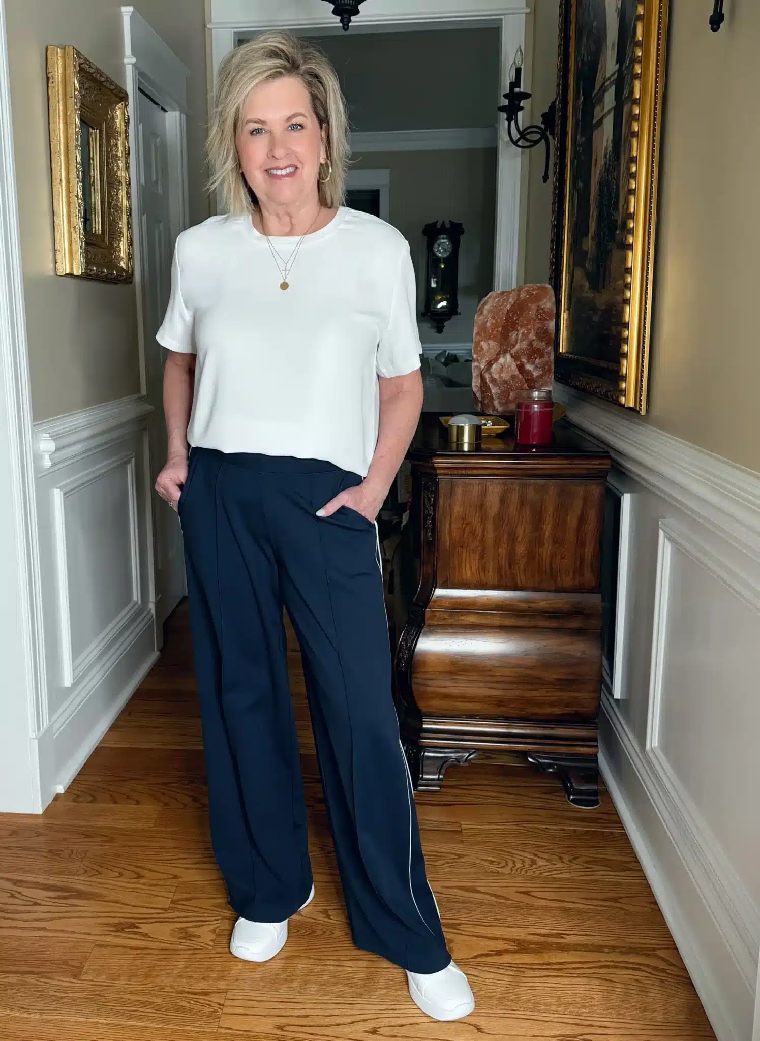 Tania Stephens wearing a white satin-look tee with wide-leg track pants and sneakers