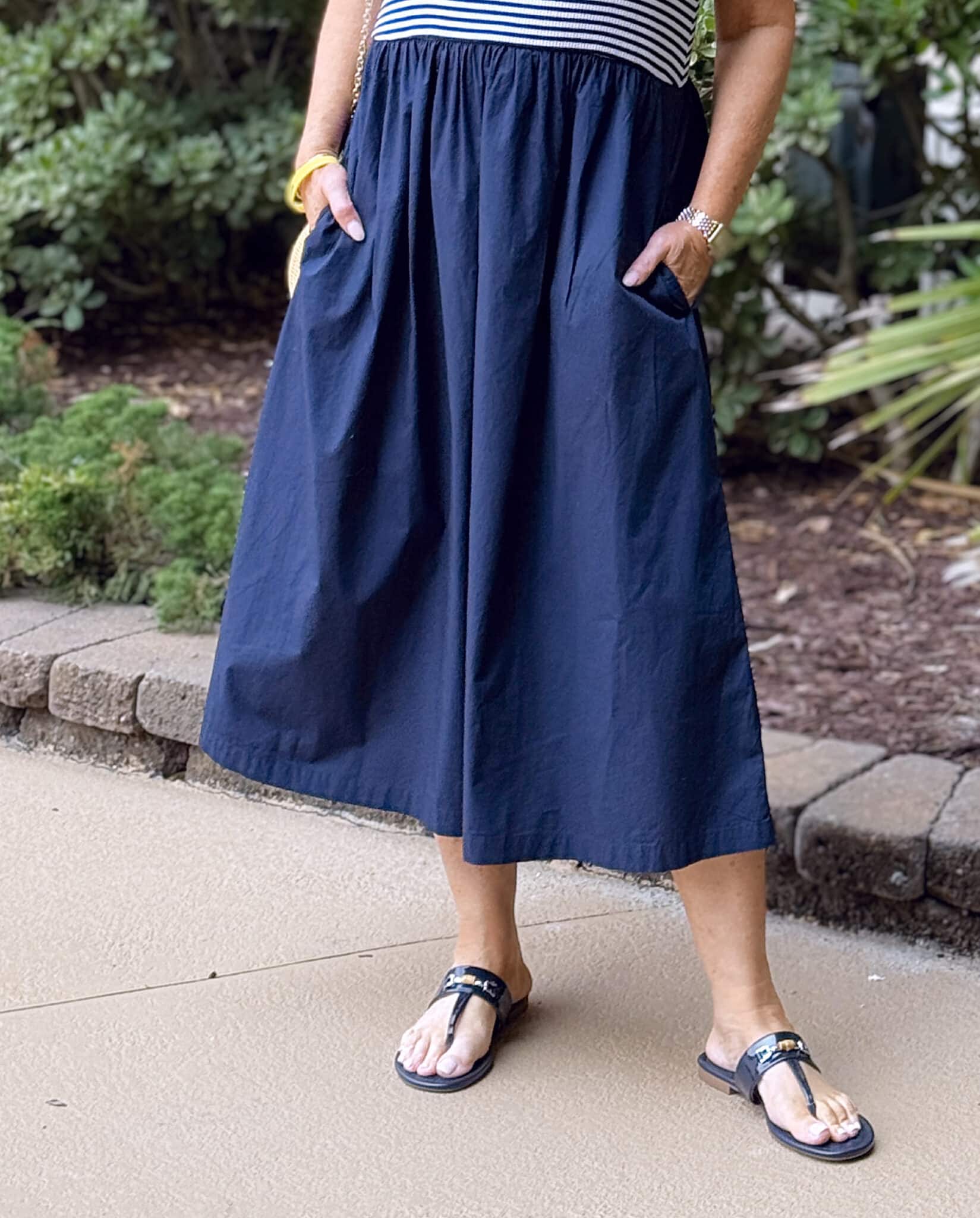 Tania Stephens at the beach wearing a navy & white striped midi dress with pockets from Talbots