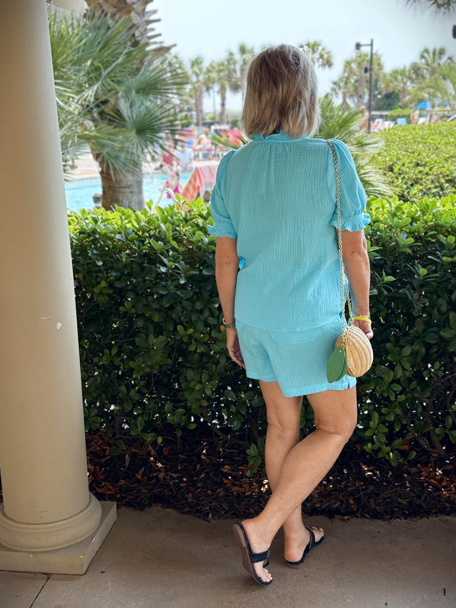 Tania Stephens at the beach showing the back of a turquoise short set from Talbots