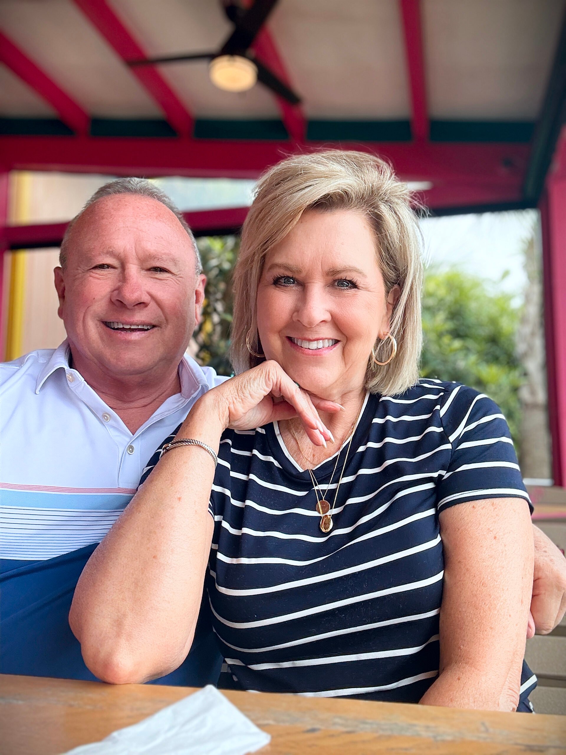 Joe and Tania sitting at a table for lunch while on vacation at the beach