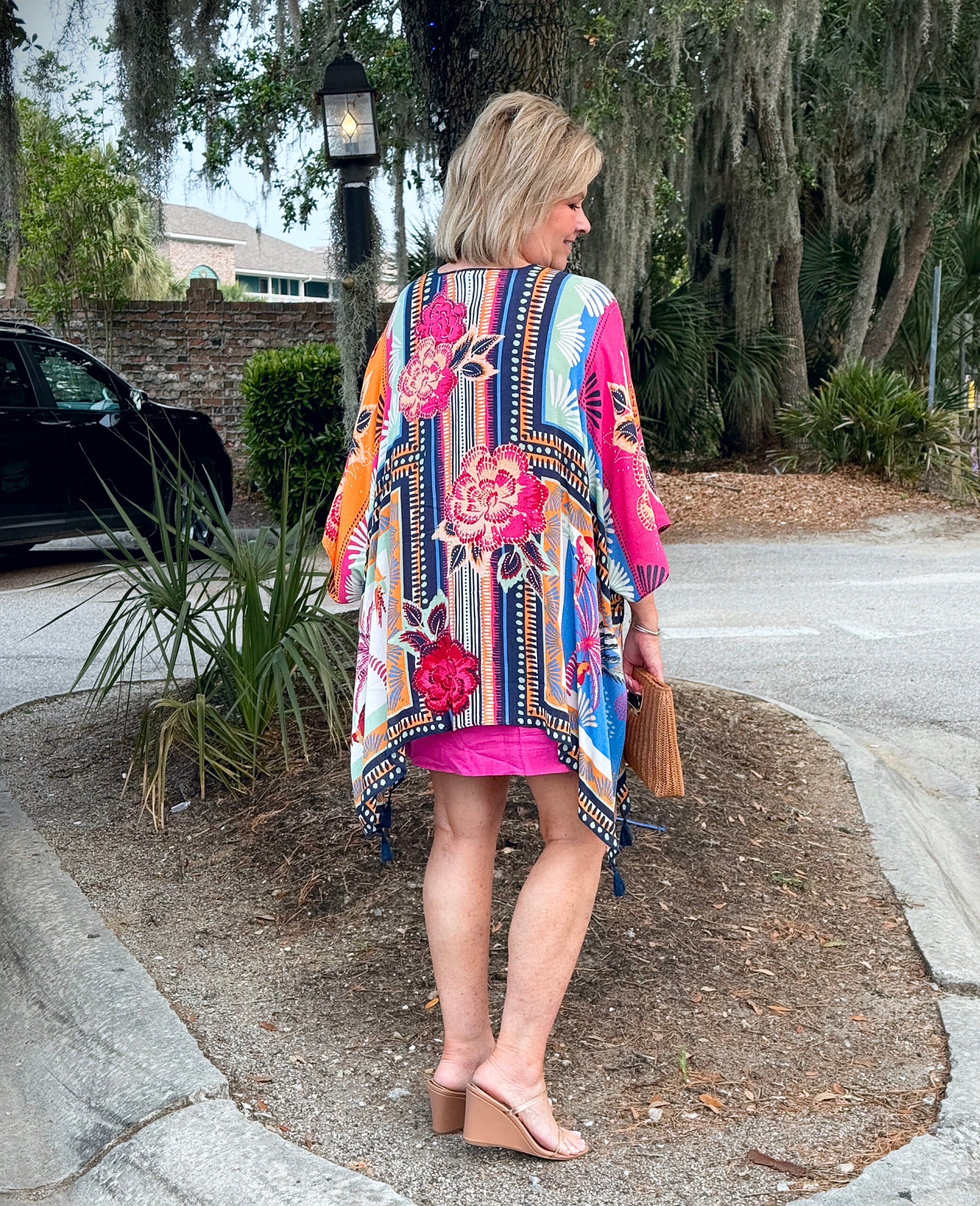 Tania wearing a colorful kimono while on vacation at the beach