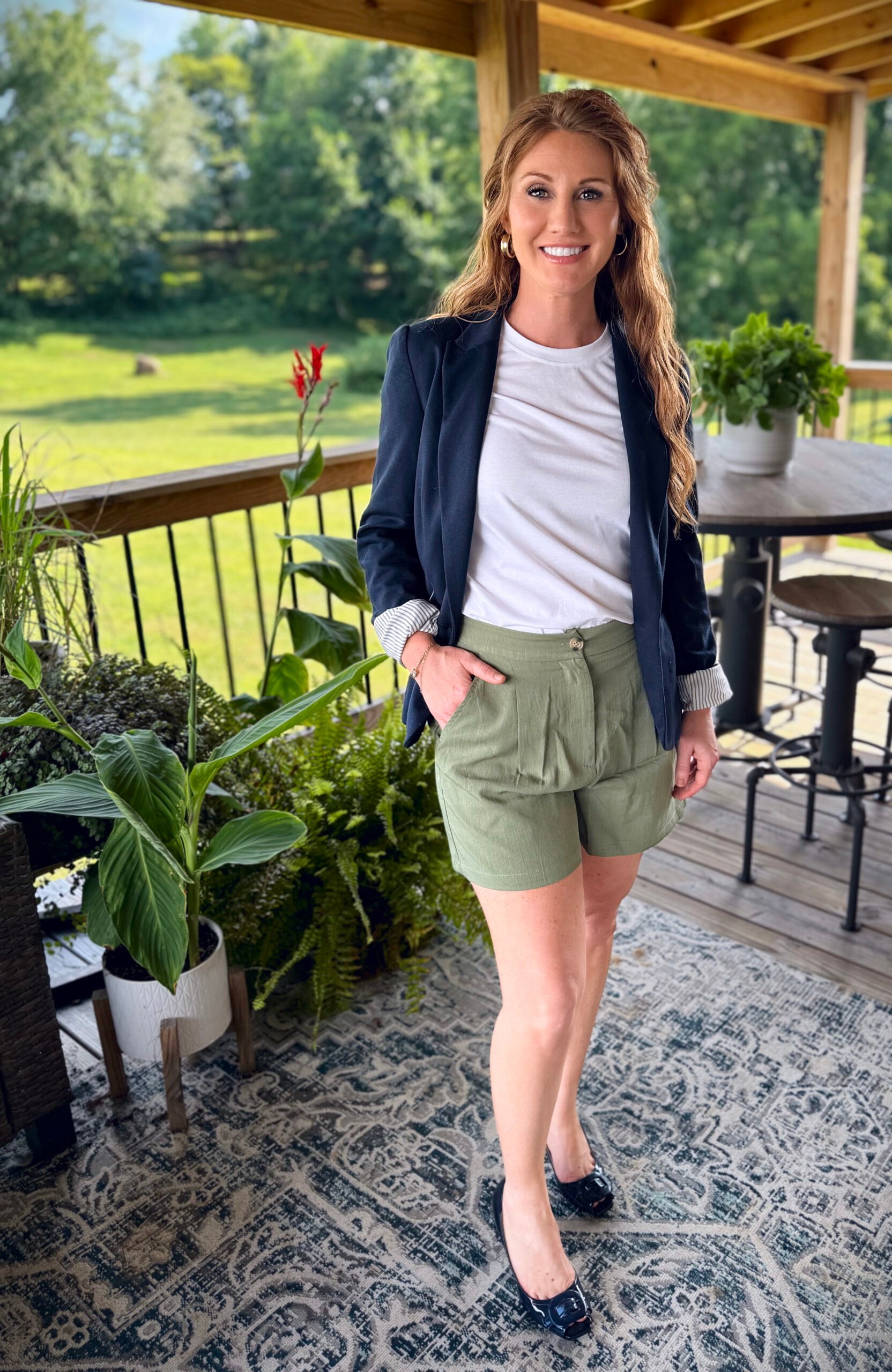 Stephanie, a petite 5'3" tall, wearing olive green shorts from Amazon with a white tee and a navy blazer